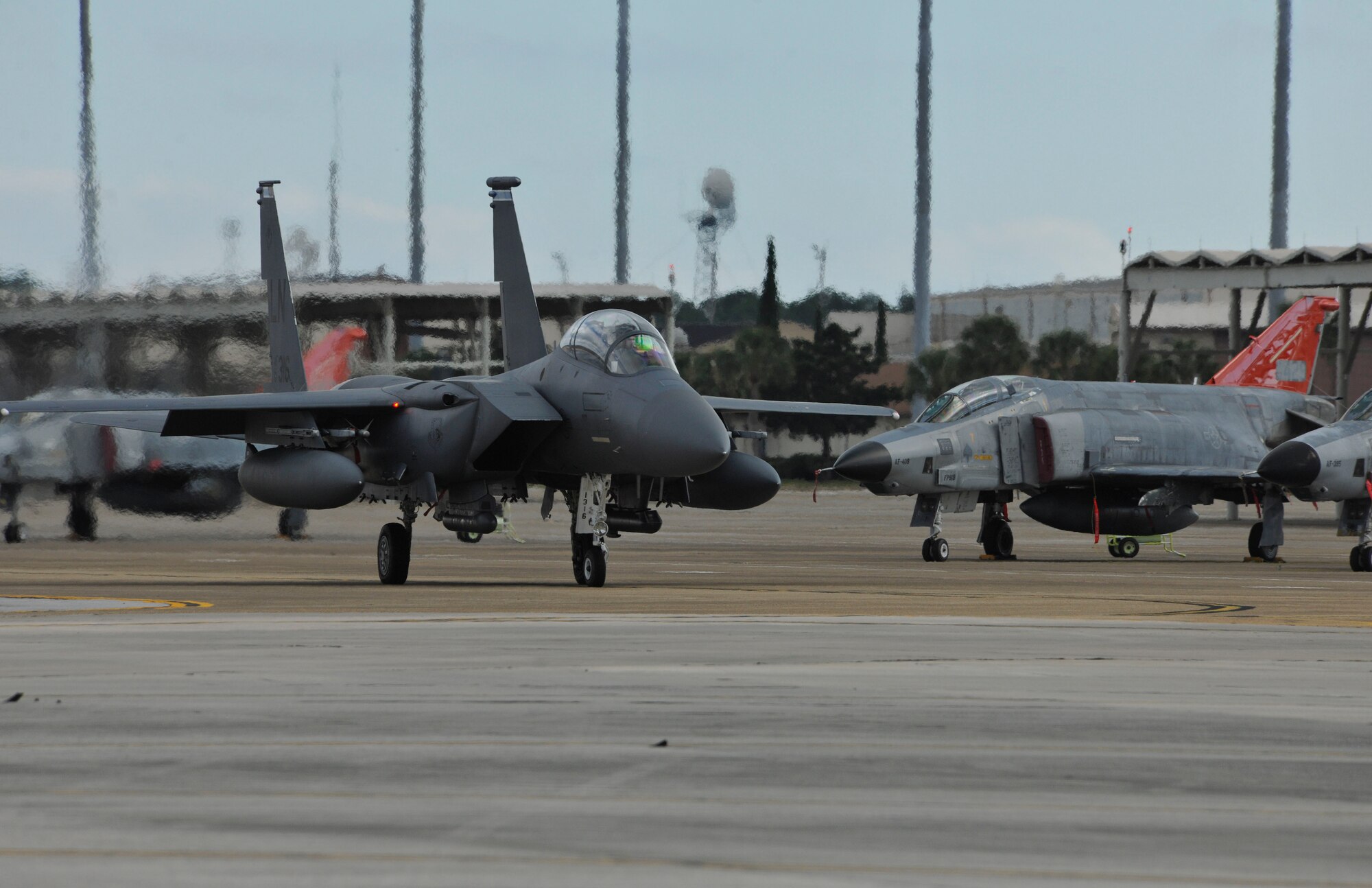 An F-15 Strike Eagle from Royal Air Force Lakenheath, England, taxis past the 82nd Aerial Target Squadron’s QF-4s during Combat Archer Feb. 6 at Tyndall Air Force Base, Fla. The 53rd Weapons Evaluation Group recently conducted the air-to-air Weapons System Evaluation Program, known as Combat Archer, which exercises and evaluates the air-to-air weapon system capability of combat aircraft. (U.S. Air Force photo by Master Sgt. J. Scott Wilcox)