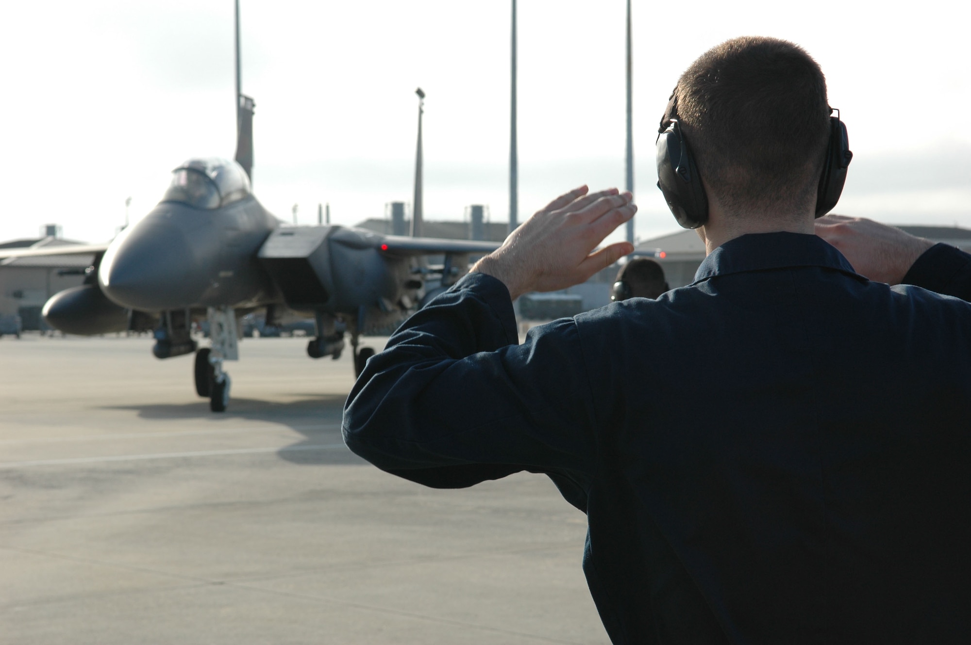 An Airman marshals a fighter jet during Combat Archer Jan. 29 at Tyndall Air Force Base, Fla. The 53rd Weapons Evaluation Group recently conducted the air-to-air Weapons System Evaluation Program, known as Combat Archer, which exercises and evaluates the air-to-air weapon system capability of combat aircraft. (U.S. Air Force photo by Master Sgt. J. Scott Wilcox)