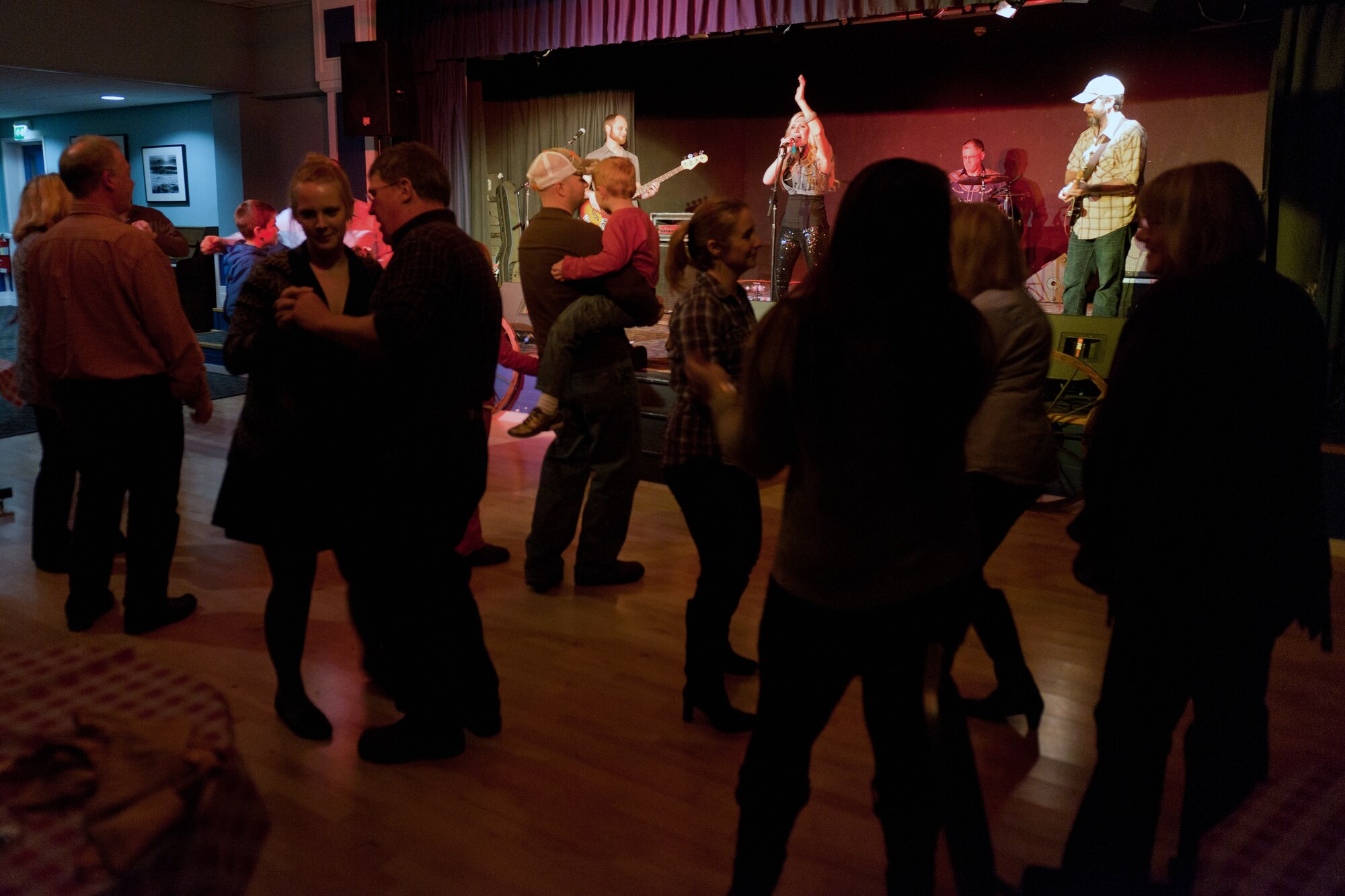 RAF ALCONBURY, United Kingdom – Members of the 501st Combat Support Wing dance to “Strawberry Wine” sung by country and western singer Ali Dee floor at the RAF Alconbury Community Activities Center during a free concert Feb. 12. Dee also performed a free concert at RAF Croughton Feb. 11. (U.S. Air Force photo by Staff Sgt. Brian Stives)
