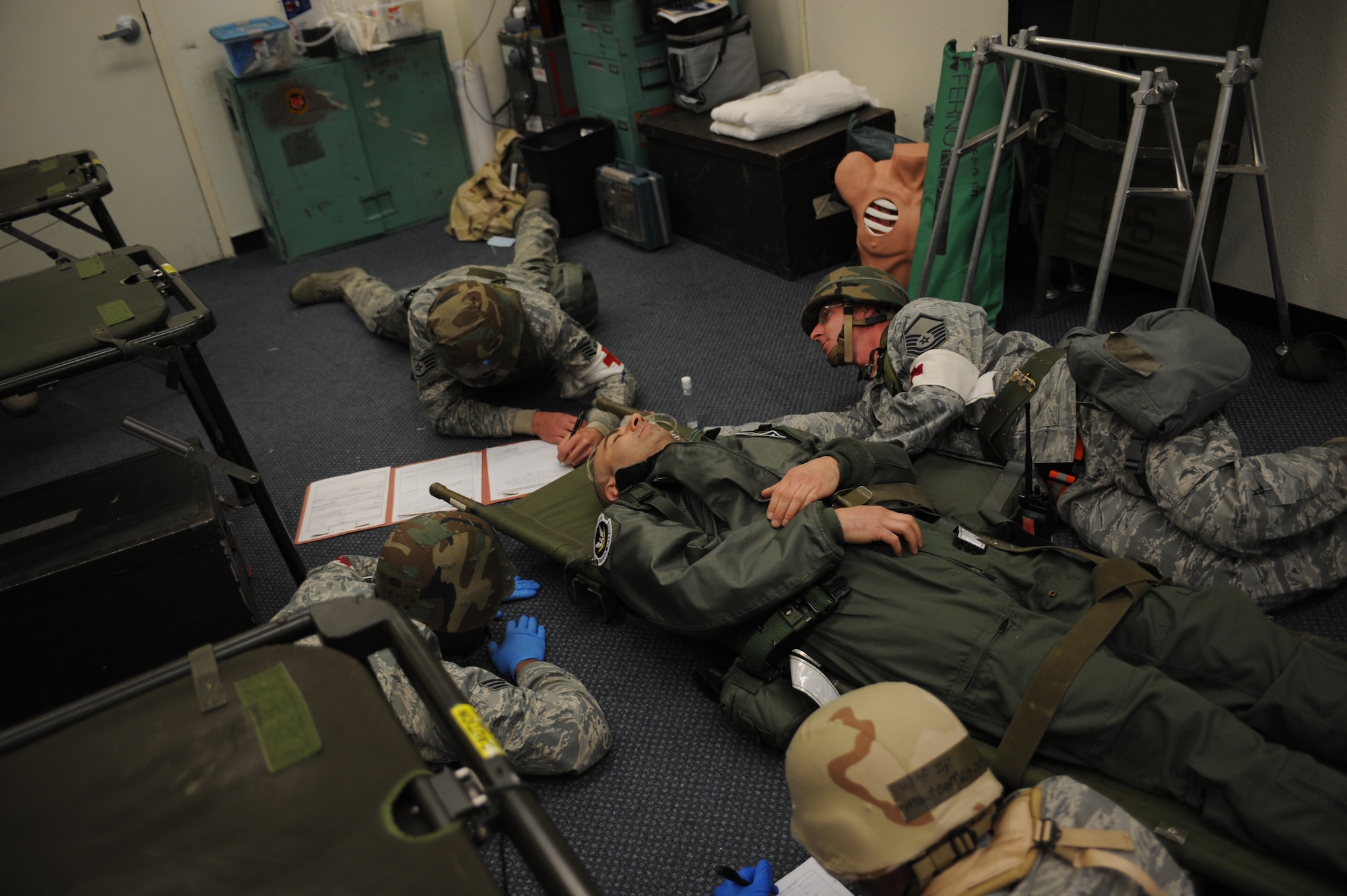 Medics from the 366th Medical Group are forced to move a patient to the ground and continue care Feb. 13, 2013, at Mountain Home Air Force Base, Idaho. Despite hardships and intense working conditions, these personnel provide excellent care to all patients who come through their door during the Sharpshooter 13-2 exercise. (U.S. Air Force photo/Senior Airman Benjamin Sutton)  