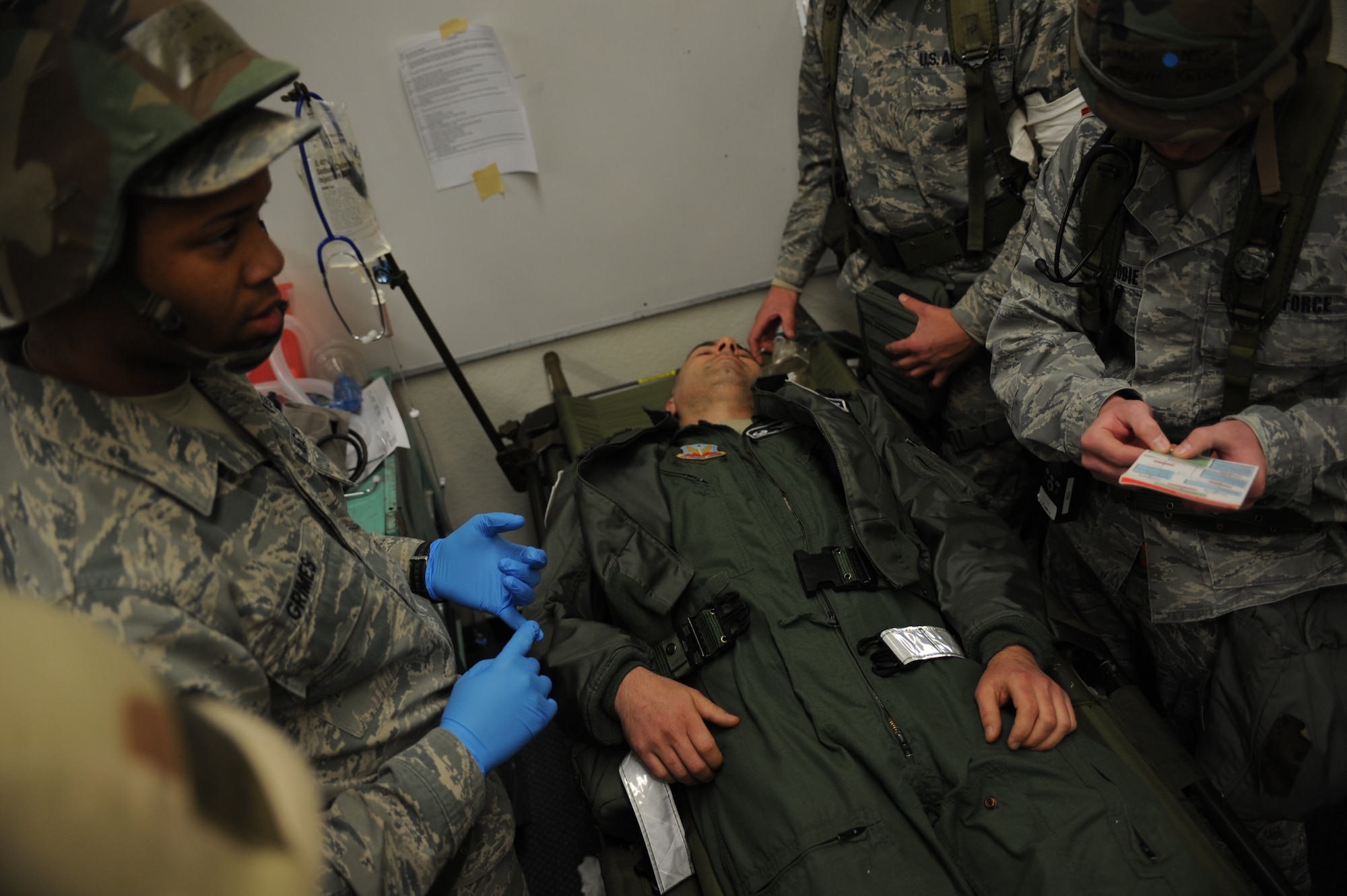 An injured patient lies unconscious on a stretcher while medical personnel evaluate him Feb. 13, 2013, at Mountain Home Air Force Base, Idaho. Medical personnel were tested on a wide variety of issues and problems throughout the Operational Readiness Exercise. (U.S. Air Force photo/Senior Airman Benjamin Sutton)