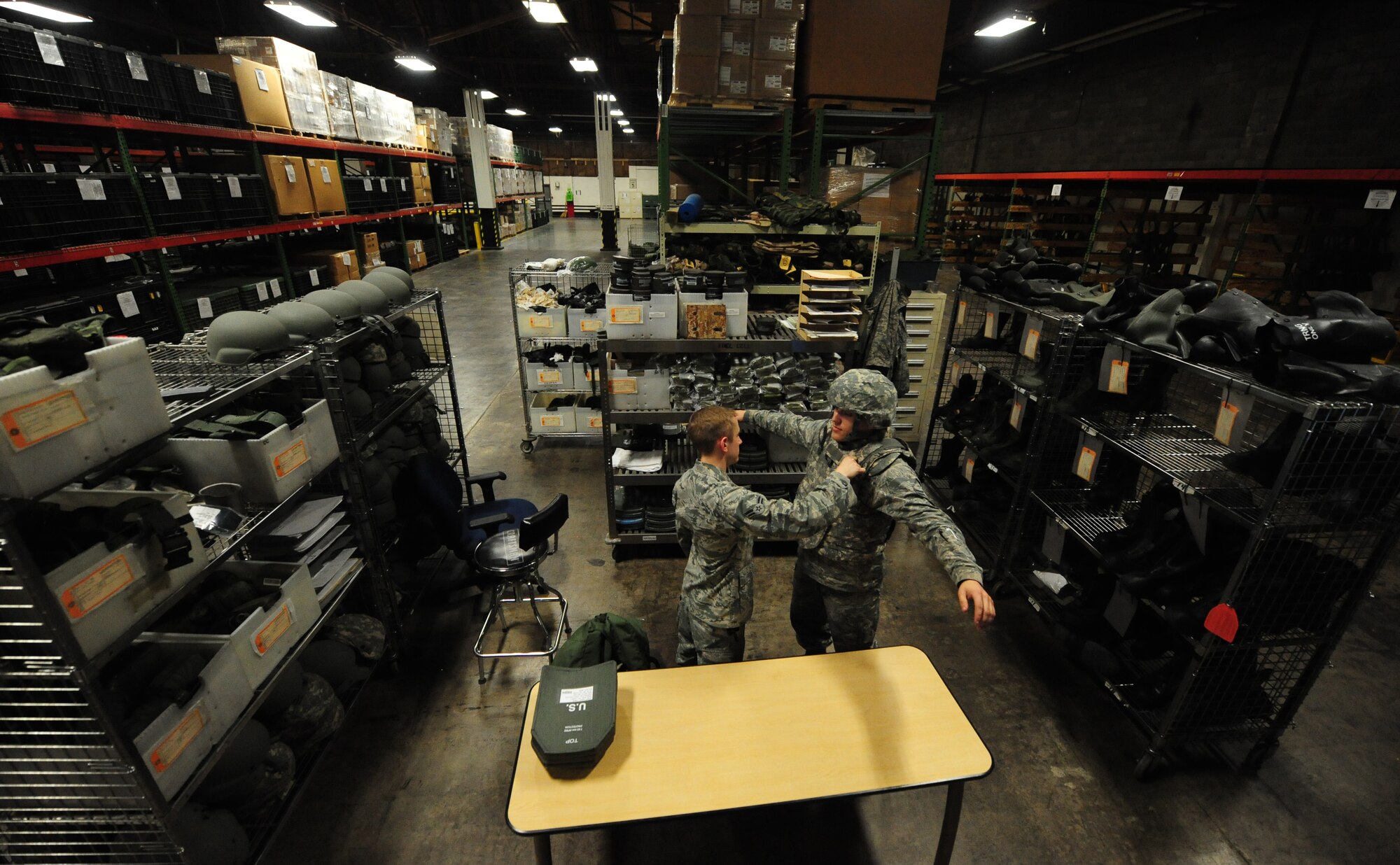 WHITEMAN AIR FORCE BASE, Mo. -- Airman 1st Class David Reddoch, 509th Logistics Readiness Squadron individual protective equipment technician, tests the fitting of body armor on Airman 1st Class Jonathan Merry, 509th LRS IPE technician, Feb. 7. IPE technicians ensure airmen are properly protected during deployments and in cold weather environments. (U.S. Air Force photo/Staff Sgt. Nick Wilson)(Released)