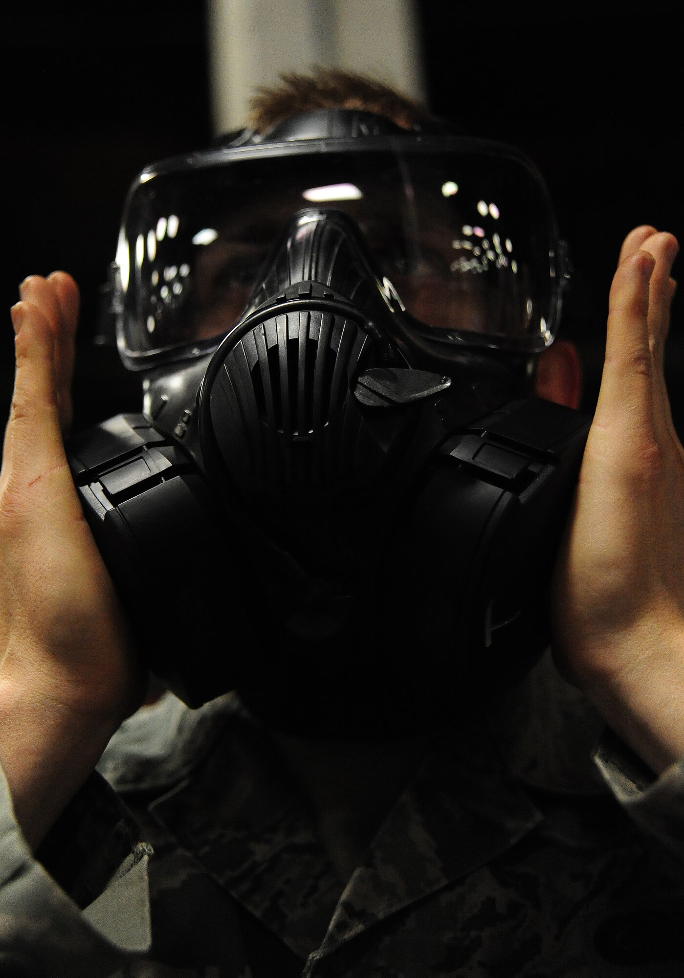 WHITEMAN AIR FORCE BASE, Mo. -- Airman 1st Class David Reddoch, 509th Logistics Readiness Squadron individual protective equipment technician, tests the fitting of a gas mask to ensure the valves have a proper seal, Feb. 7. In addition to providing serviceable gas masks, IPE technicians have a mission to ensure the base populace is outfitted with serviceable life-saving equipment for training and deployments. (U.S. Air Force photo/Staff Sgt. Nick Wilson) (Released)