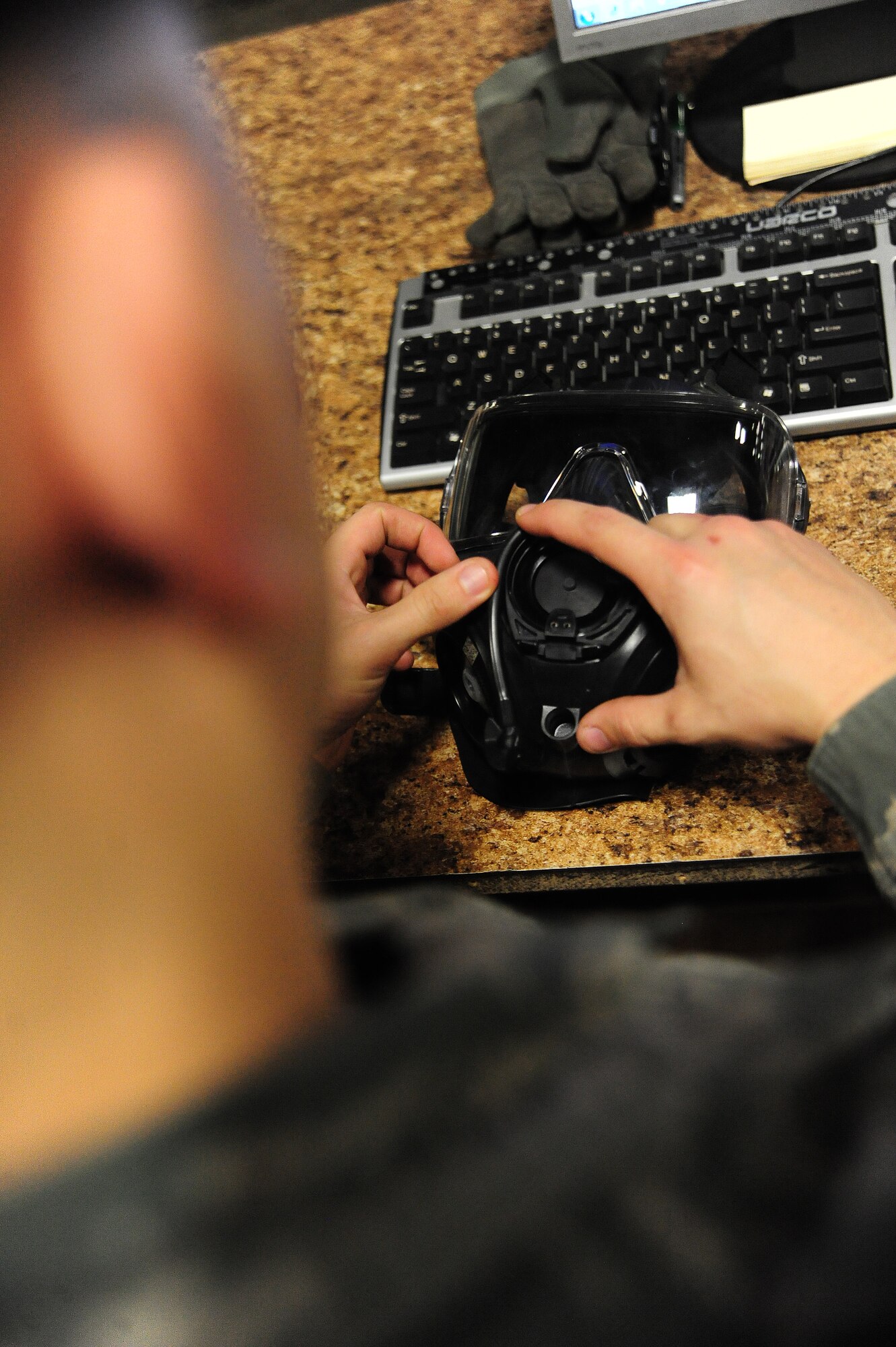 WHITEMAN AIR FORCE BASE, Mo. -- Airman 1st Class Jonathan Merry, 509th Logistics Readiness Squadron individual protective equipment technician, tests the fitting of a gas mask to ensure the valves have a proper seal, Feb. 7. A loose seal could mean the difference between life and death for an Airman under a chemical attack, according to Merry. (U.S. Air Force photo/Staff Sgt. Nick Wilson) (Released)