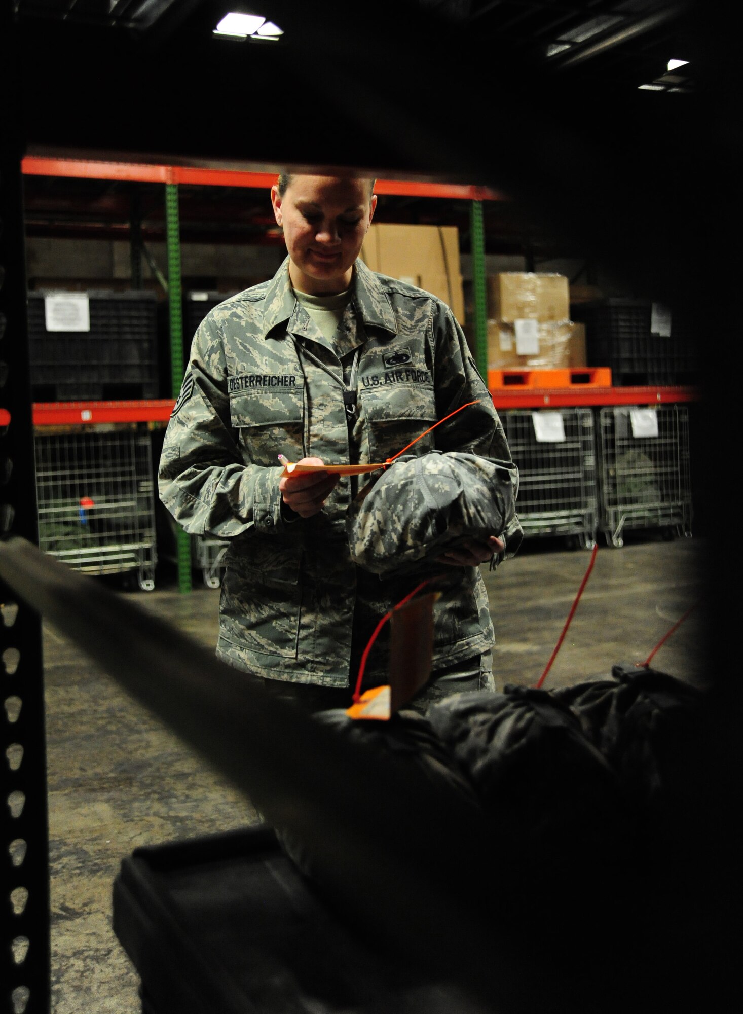 WHITEMAN AIR FORCE BASE, Mo. -- Staff Sgt. Erica Oesterreicher, 509th Logistics Readiness Squadron individual protective equipment technician, inspects the service tag on an individual first aid kit, Feb. 7. Part of the inspection process includes making sure items in the inventory are not expired. (U.S. Air Force photo/Staff Sgt. Nick Wilson) (Released)