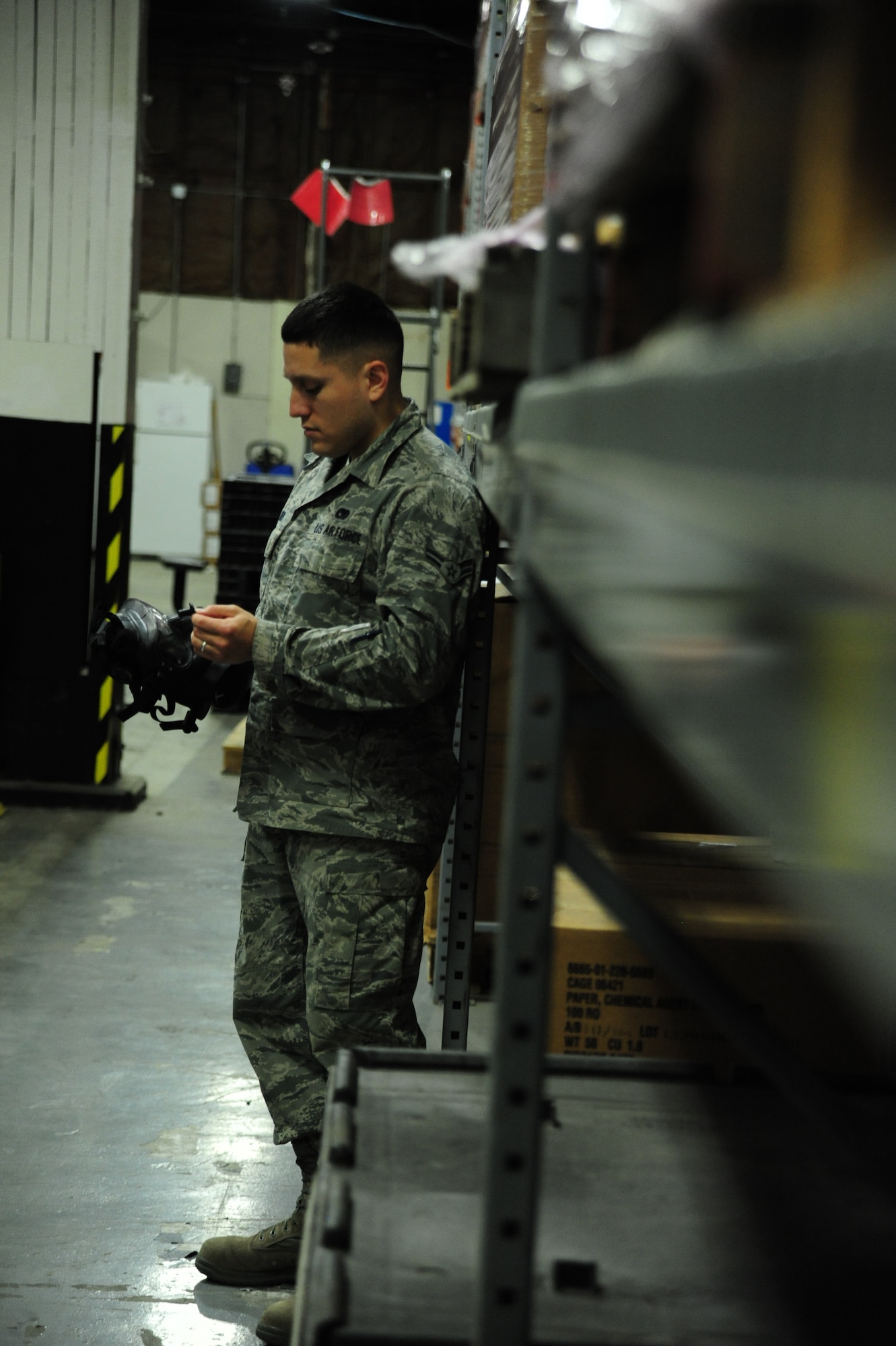 WHITEMAN AIR FORCE BASE, Mo. -- Airman 1st Class David Reddoch, 509th Logistics Readiness Squadron individual protective equipment technician, uses a fork lift to pull down chemical gear for an inventory inspection, Feb. 7. In addition to using heavy equipment, IPE technicians are also trained on a variety of tasks including customer service and maintaining inventory items. (U.S. Air Force photo/Staff Sgt. Nick Wilson) (Released)