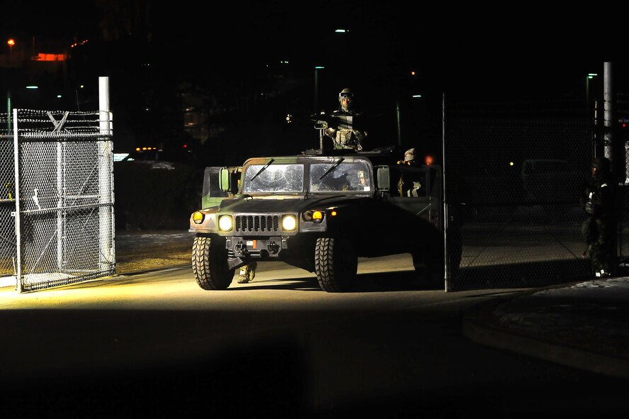 51st Security Forces members take defensive positions as they roll through the Logistics Readiness Squadron gate to engage insurgents during operational readiness exercise Beverly Bulldog 13-02 on Osan Air Base, Republic of Korea, Feb.13, 2013.  Throughout the week, Osan Mustangs will demonstrate their ability to operate in a chemical environment ensuring the mission can be completed under any conditions.  (U.S. Air Force photo/Staff Sgt. Emerson Nuñez)
