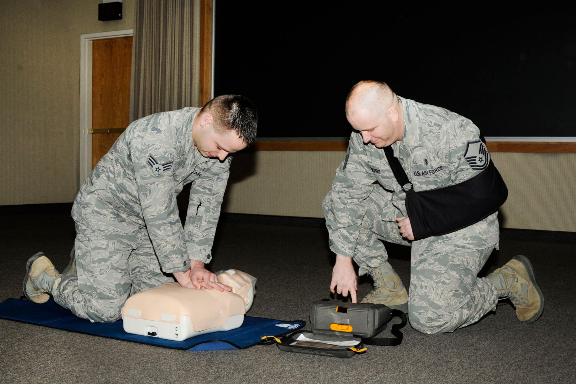 HANSCOM AIR FORCE BASE, Mass. -- Senior Airman Michael Trala (left) and Master Sgt. Brent Whitby, both members of the 66th Medical Squadron, demonstrate the correct procedures for cardiopulmonary resuscitation during a CPR informational course at the Hanscom Conference Center Feb. 6. CPR is a lifesaving technique useful in many emergency situations. (U.S. Air Force photo by Linda LaBonte Britt)