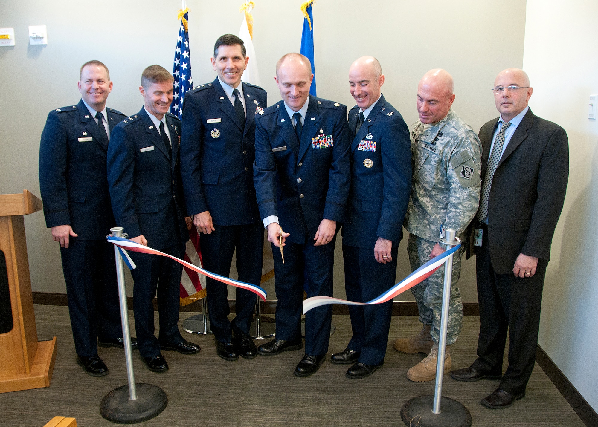 HANSCOM AIR FORCE BASE, Mass. -- (left to right) U.S. Air Force Col. Frank Glenn, Maj. Gen. Craig S. Olson, Lt. Gen. C.D. Moore II, Maj. Aron Potter, Col. Lester A. Weilacher, U.S. Army Col. Charles Samaris and Joe Spangenberger cut the ribbon on the new Mental Health facility attached to the 66th Medical Squadron clinic Feb. 13. Construction on the facility began in May 2012 and will officially open to patients Feb. 26. (U.S. Air Force photo by Mark Wyatt)