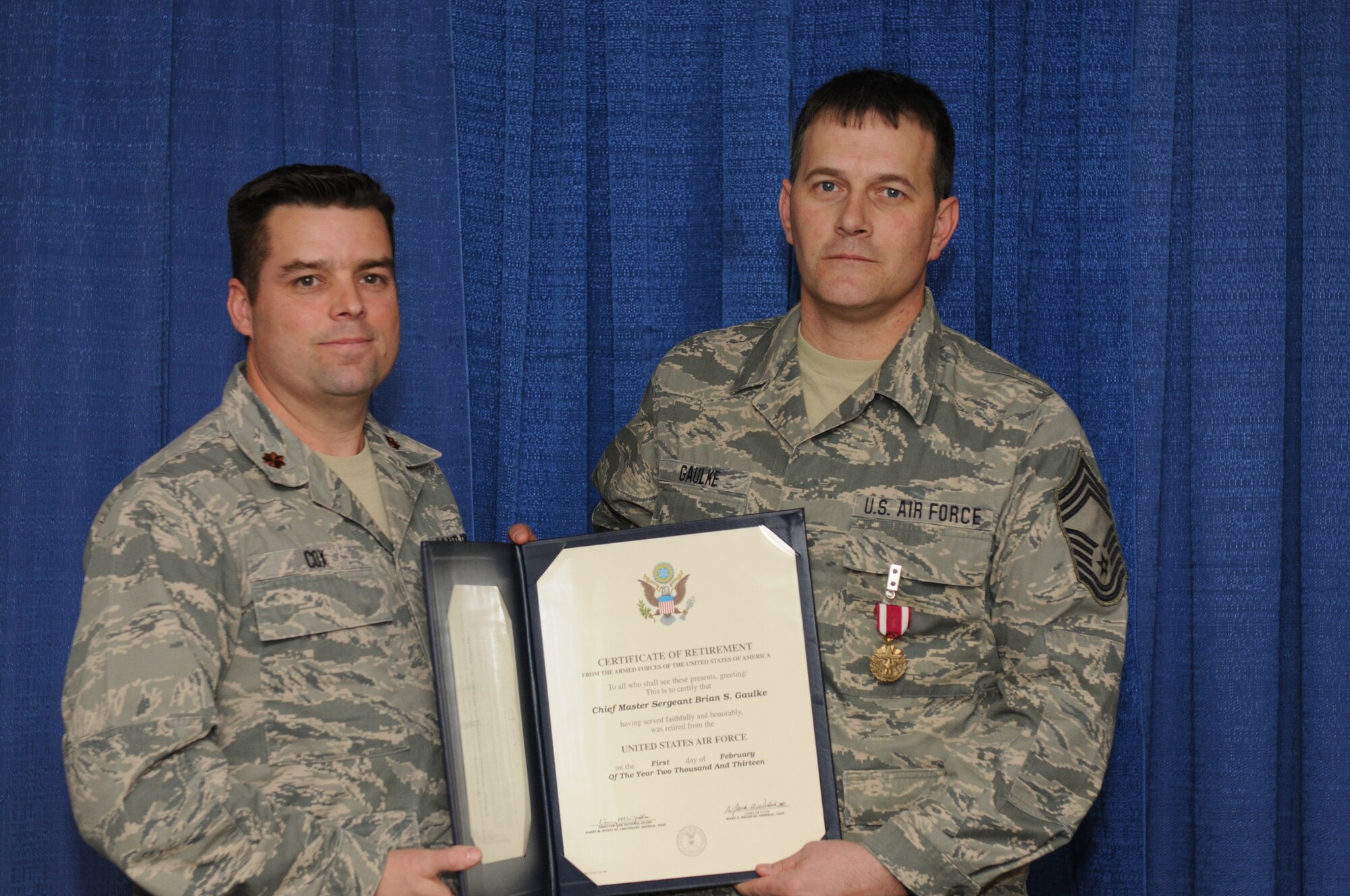 New York Air National Guard Chief Master Sgt. Brian Gaulke (right) receives a Certificate of Retirement from Maj. Patrick Cox, Commander 274th Air Support Operation Squadron, during a 2 February 2013 retirement ceremony held at Hancock Field Air National Guard Base, Syracuse, NY. Chief Gaulke also received a Meritorious Service Medal during the ceremony. Chief Gaulke was one of the first members of the 274th ASOS after it stood up at Hancock Field. (NY Air National Guard photo by Senior Airman Duane Morgan/Released)