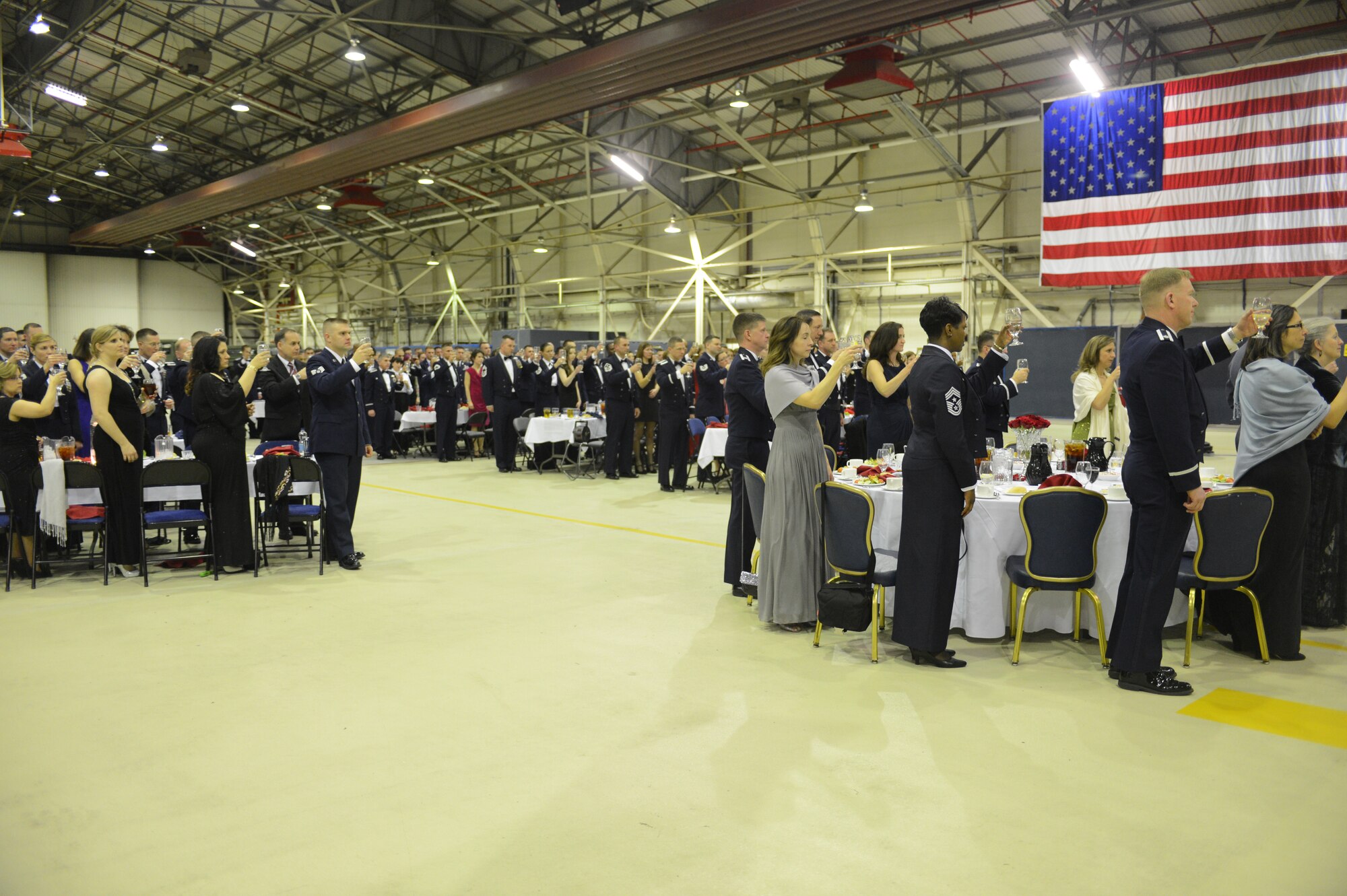 ROYAL AIR FORCE LAKENHEATH, England -- Members of the 48th Fighter Wing raise their glasses to honor missing and fallen service members during the 48th FW Annual Awards Banquet at Hangar 7 Feb. 9, 2013. A POW/MIA table was present at the banquet to represent the missing service members. (U.S. Air Force photo by Airman 1st Class Dana J. Butler) 