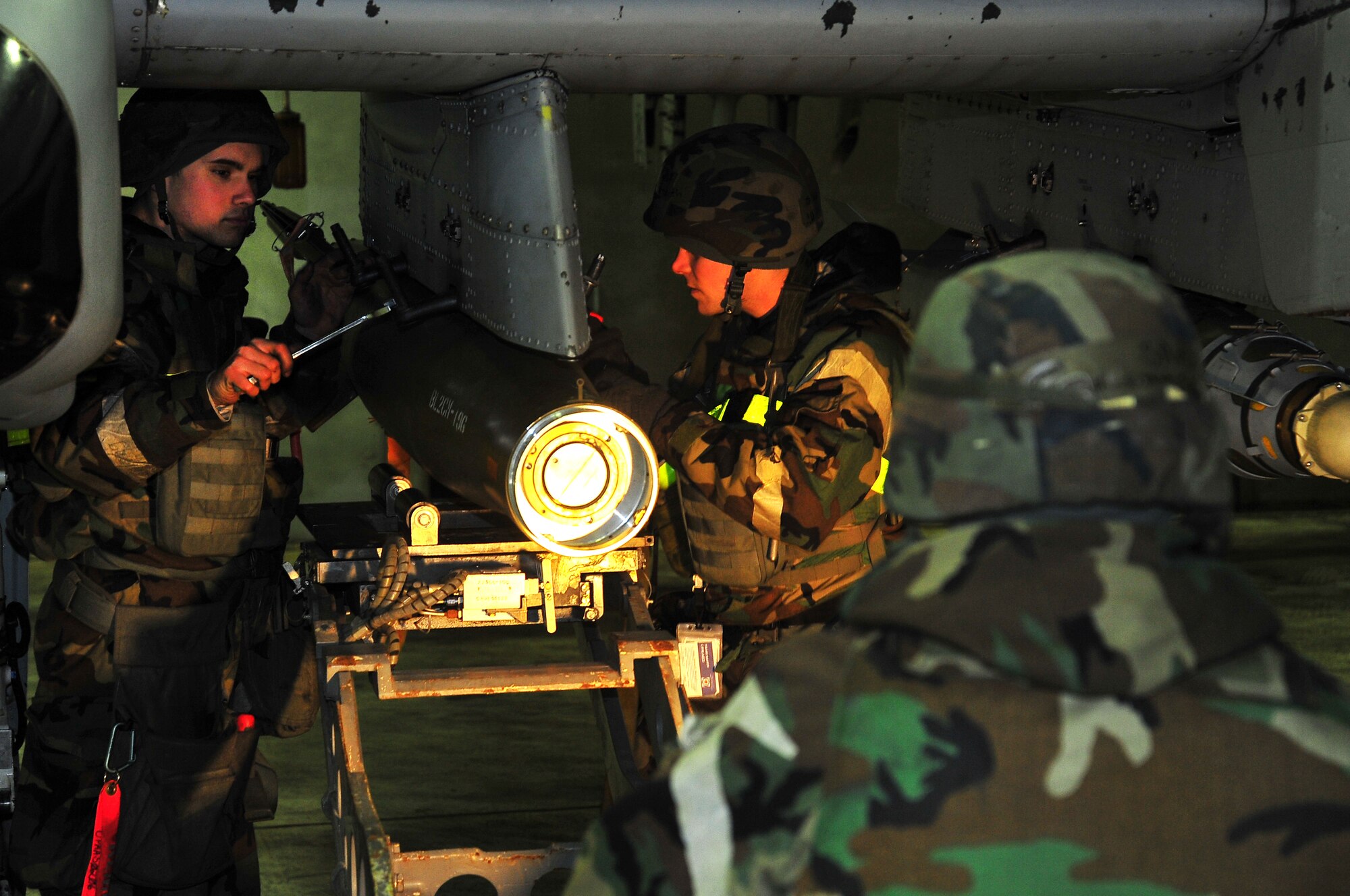 Senior Airman Joel Valdez, 51st Maintenance Operation Squadron load crew member, and Staff Sgt. Kenneth Merritt, 51st Maintenance Operation Squadron lead crew chief, load munitions onto an A-10 Thunderbolt II on Osan Air Base, Republic of Korea, Feb.13, 2013.  Operational readiness exercise Beverly Bulldog 13-02 tests Osan’s abilities during heightened states of readiness. (U.S. Air Force photo/Staff Sgt. Emerson Nuñez)