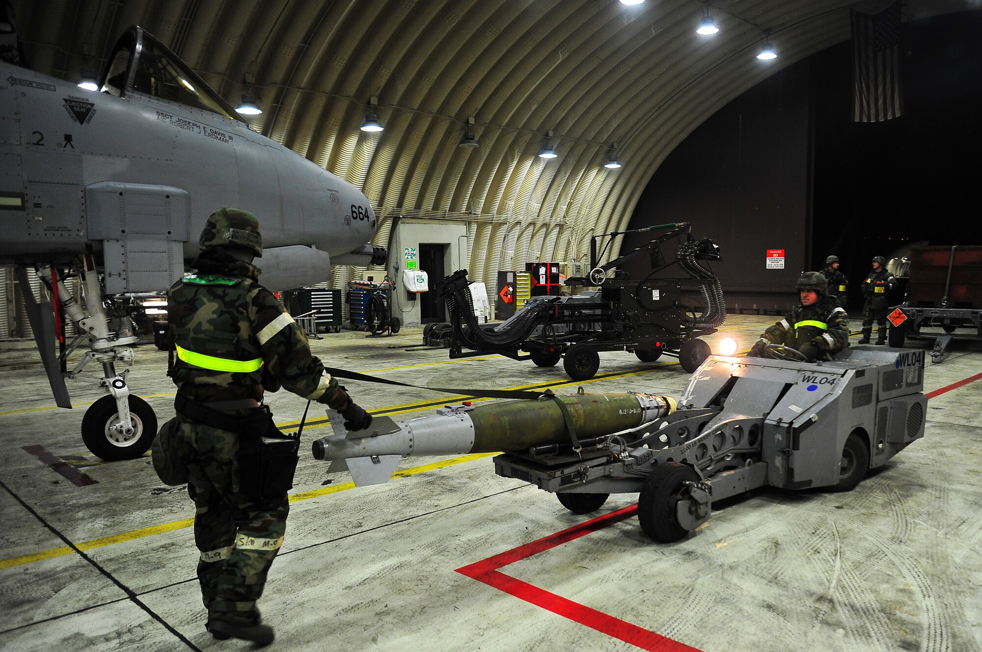 Staff Sgt. Kenneth Merritt, left, 51st Maintenance Operations Squadron lead crew
chief, helps Senior Airman Steven Davarich, 51st MOS lead crew member, guide a missile onto an A-10 Thunderbolt II on Osan Air Base, Republic of Korea, Feb.13, 2013.  Load crew members practiced procedures to sharpen their loading skills during operational readiness exercise Beverly Bulldog 13-02. (U.S. Air Force photo/Staff Sgt. Emerson Nuñez)
