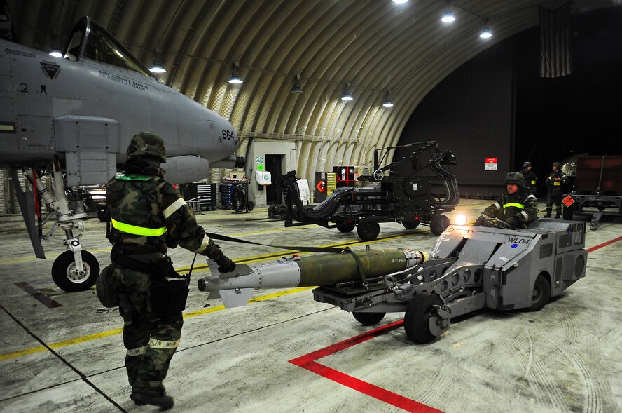 Staff Sgt. Kenneth Merritt, left, 51st Maintenance Operations Squadron lead crew
chief, helps Senior Airman Steven Davarich, 51st MOS lead crew member, guide a missile onto an A-10 Thunderbolt II on Osan Air Base, Republic of Korea, Feb.13, 2013.  Load crew members practiced procedures to sharpen their loading skills during operational readiness exercise Beverly Bulldog 13-02. (U.S. Air Force photo/Staff Sgt. Emerson Nuñez)
