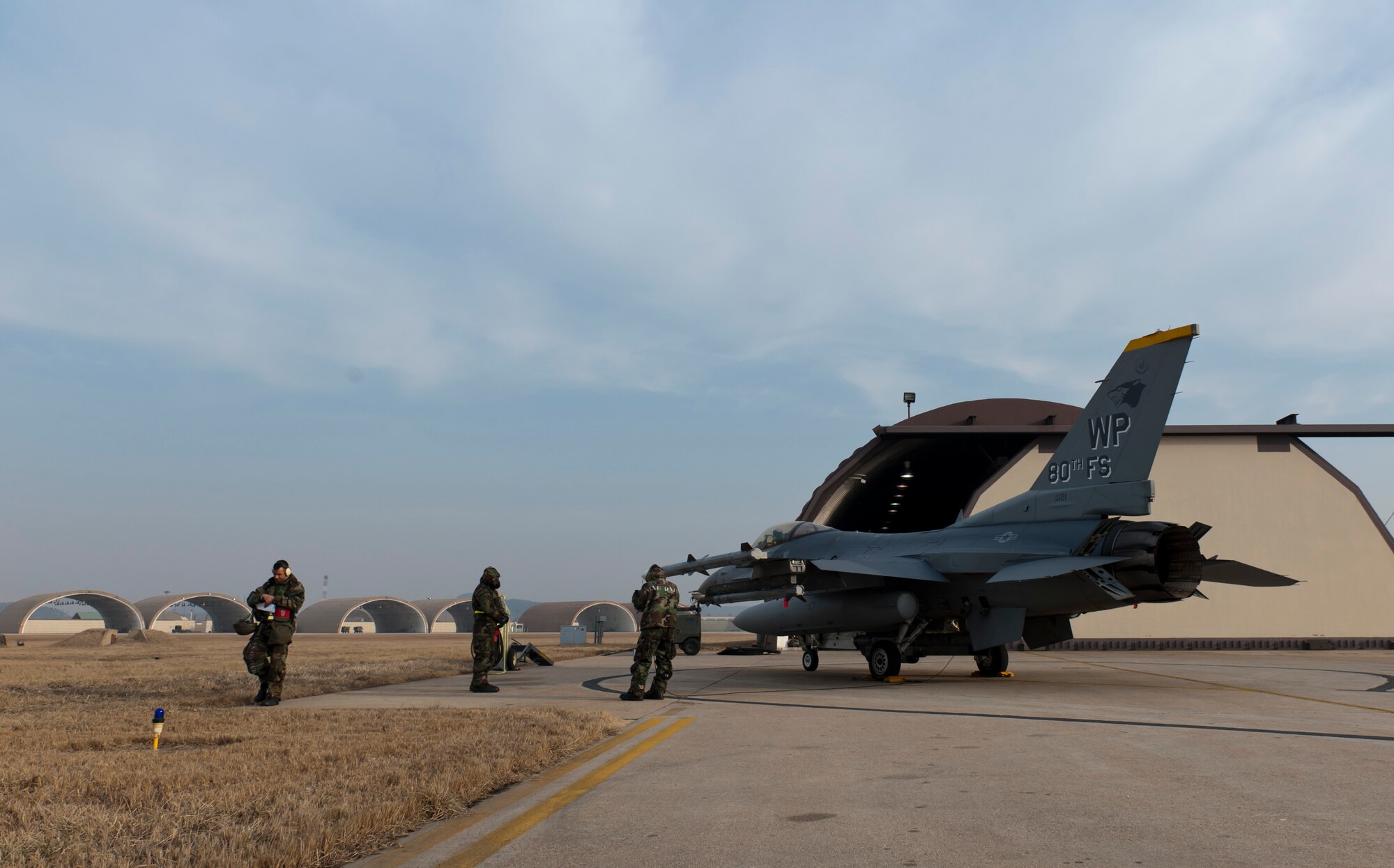 Airmen from the 8th Aircraft Maintenance Squadron prepare to decontaminate an F-16 Fighting Falcon during exercise Beverly Bulldog 13-2 at Kunsan Air Base, Republic of Korea Feb. 14, 2013. The jet landed in a simulated chemical environment and the aircraft maintainers ensured all surfaces were properly decontaminated. (U.S. Air Force photo by Tech. Sgt. Michael Schocker/Released)