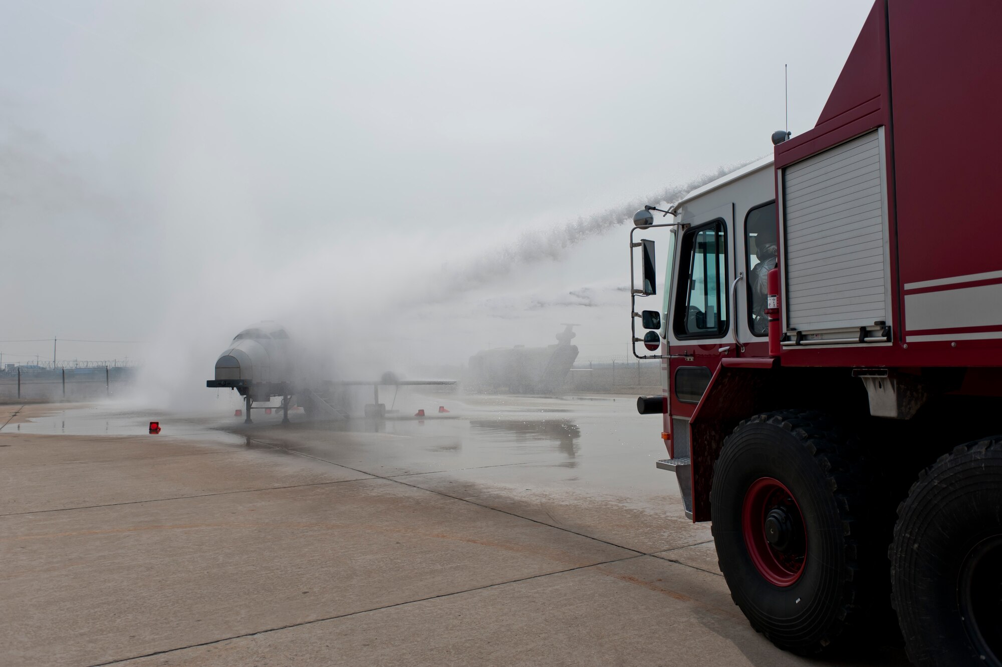 A combined group of firefighters  from the 8th Civil Engineer Squadron at Kunsan Air Base, Republic of Korea and from the Republic of Korea air force’s 38th Fighter Group race to the scene of a simulated burning aircraft and extinguish the fire during exercise Beverly Bulldog 13-2 at Kunsan Air Base, RoK, Feb. 14, 2013. After putting out the flames, firefighters from the partner nations rushed to the aircraft and rescued five survivors. (U.S. Air Force photo by Tech. Sgt. Michael Schocker/Released)