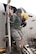 Staff Sgt. Bryan Tune, 8th Aircraft Maintenance Squadron, is assisted off the aircraft by a Republic of Korea air force firefighter after sustaining shrapnel in his left leg during a simulated aircraft incident during exercise Beverly Bulldog 13-2 at Kunsan Air Base, Republic of Korea, Feb. 14, 2013. Tune and four other Airmen were trapped in the downed aircraft until the fire department rescued them. (U.S. Air Force photo by Tech. Sgt. Michael Schocker/Released)