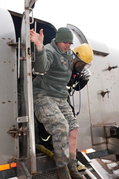 Staff Sgt. Bryan Tune, 8th Aircraft Maintenance Squadron, is assisted off the aircraft by a Republic of Korea air force firefighter after sustaining shrapnel in his left leg during a simulated aircraft incident during exercise Beverly Bulldog 13-2 at Kunsan Air Base, Republic of Korea, Feb. 14, 2013. Tune and four other Airmen were trapped in the downed aircraft until the fire department rescued them. (U.S. Air Force photo by Tech. Sgt. Michael Schocker/Released)