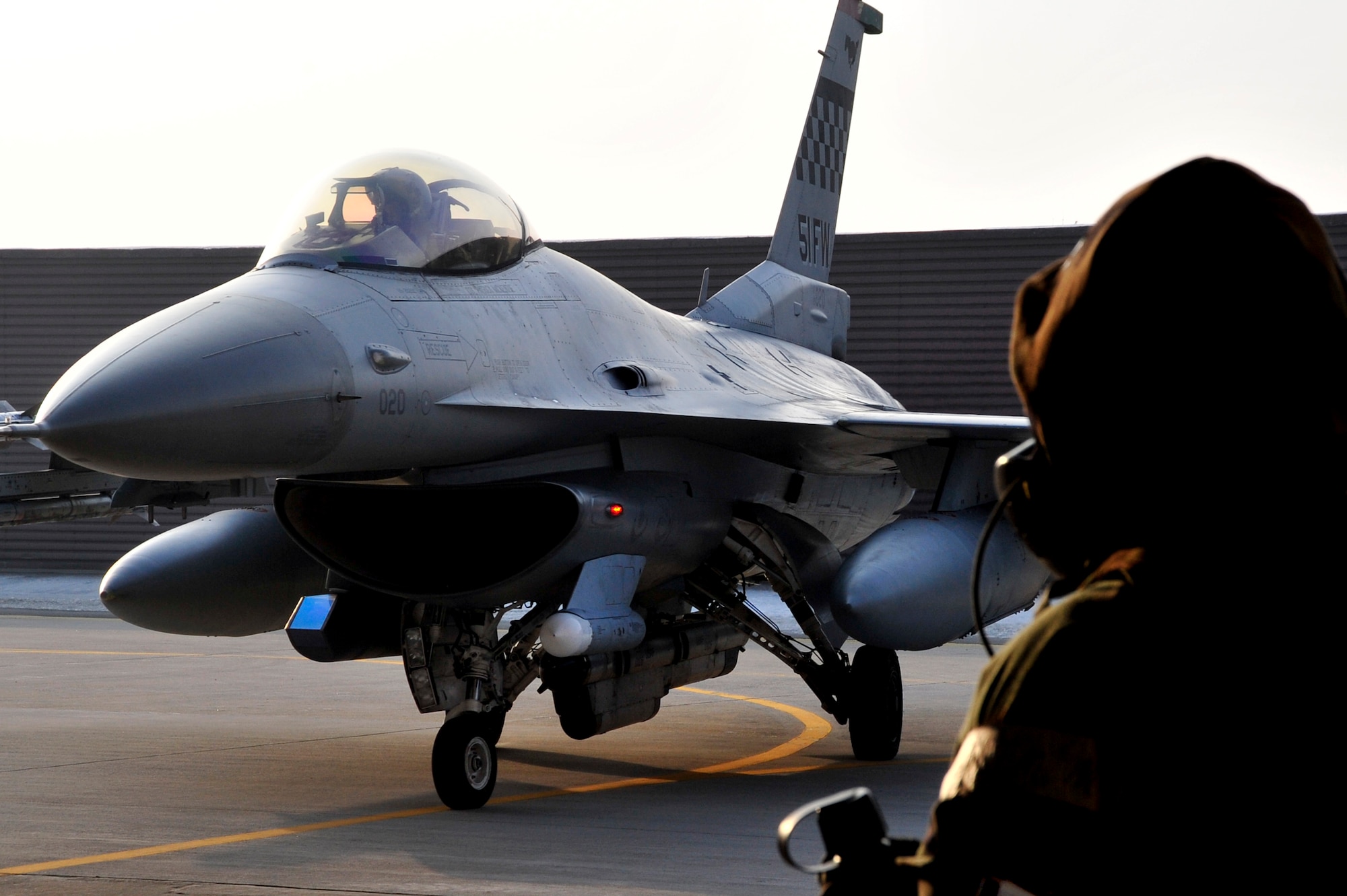 Senior Airman Thomas Hooten, 51st Maintenance Squadron maintainer, guides an F-16 Flying Falcon during operational readiness exercise, Beverly Bulldog 13-02, at Osan Air Base, Republic of Korea, Feb. 14, 2013. During OREs, Airmen highlight their ability to position, employ, and sustain forces and showcase operational readiness. BB 13-02 is the second ORE of the 2013. (U.S. Air Force photo/Airman 1st Class Alexis Siekert)