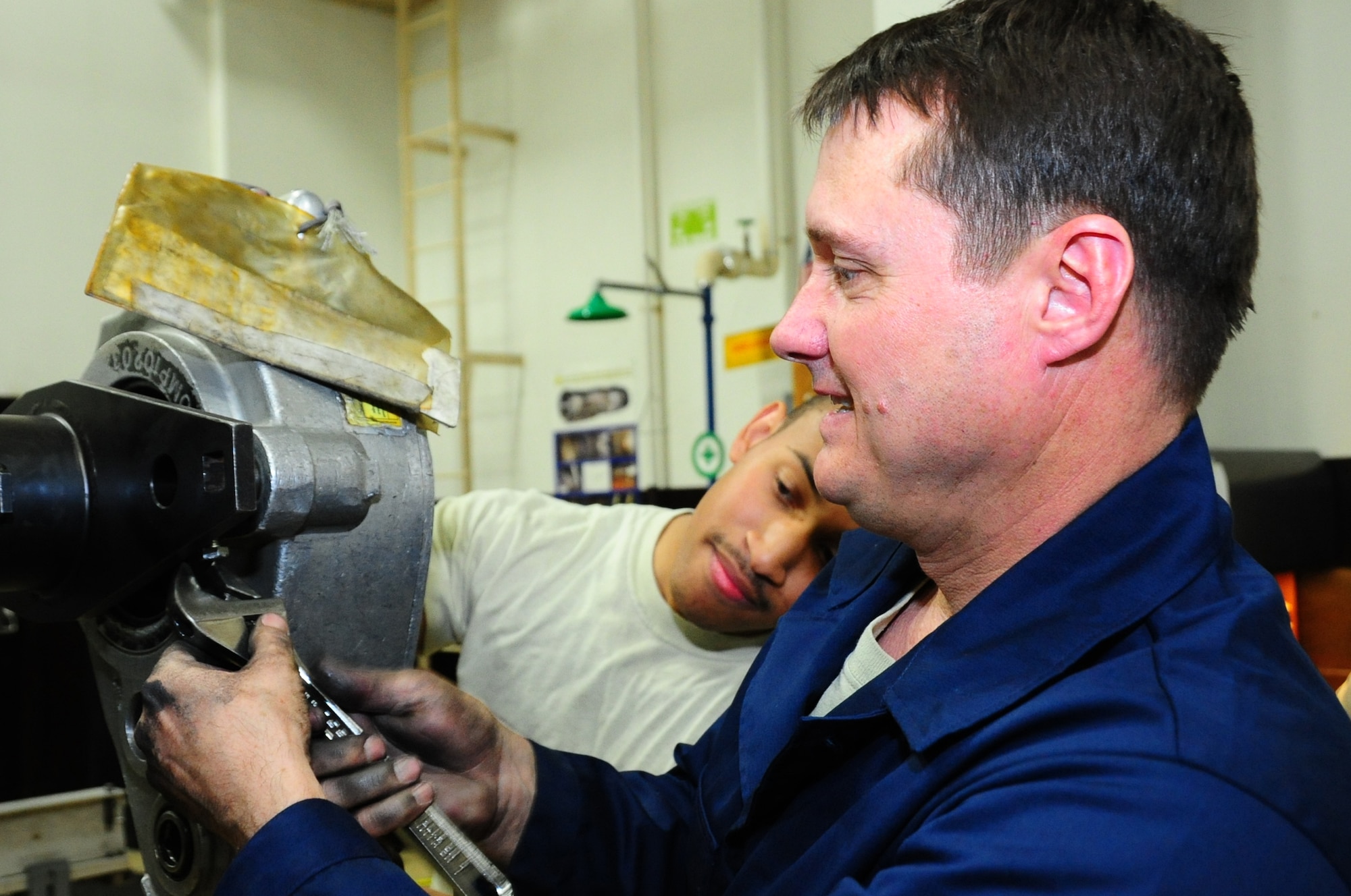 U.S. Air Force Col. Matthew Dana (front), 35th Fighter Wing vice commander, tightens a bolt on the Sweeney torque multiplier as Senior Airman Michael Bond, 35th Maintenance Squadron aerospace propulsion journeyman, ensures the equipment is secure during the Dirty Jobs Program on Misawa Air Base, Japan, Feb. 13, 2013.  Bond is able to share his experience and tricks of his trade with his base leadership, thanks to the opportunity given to him by the Dirty Jobs Program.  (U.S. Air Force photo by Staff Sgt. April Quintanilla)