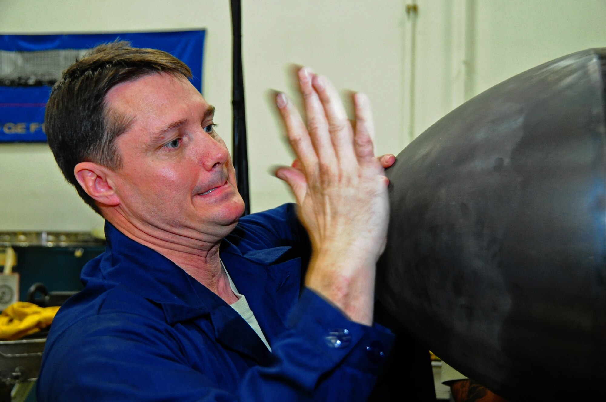 U.S. Air Force Col. Matthew Dana, 35th Fighter Wing vice commander, tries to slap the aft center body off of the major assembly low pressure turbine as part of the 35th Maintenance Squadron during the Dirty Jobs Program on Misawa Air Base, Japan, Feb. 13, 2013.  The program gives 35 MXS the chance to get the wing leadership up to their elbows in grease.  (U.S. Air Force photo by Staff Sgt. April Quintanilla)