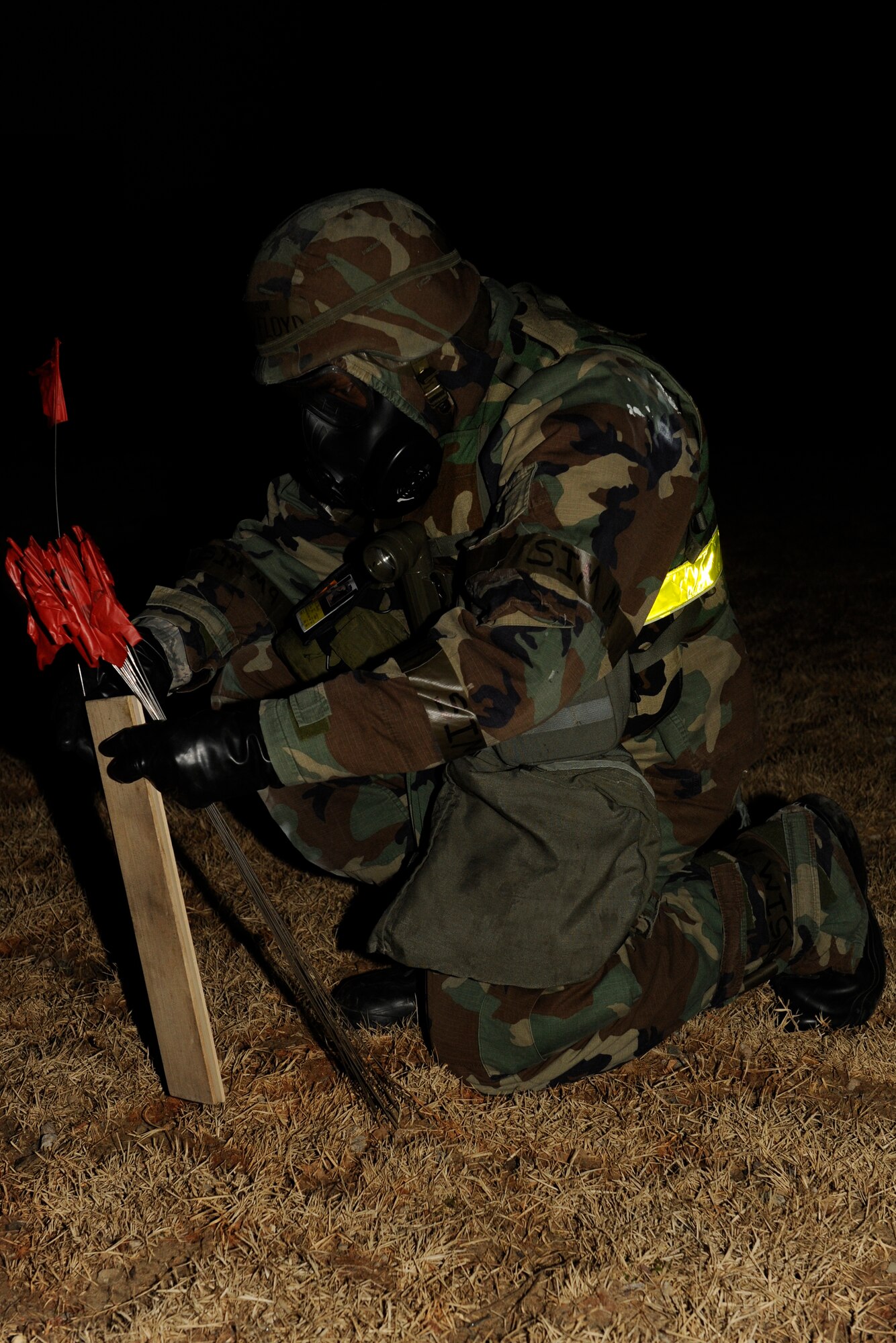 KUNSAN AIR BASE, Republic of Korea -- Senior Airman Jerrod Floyd, 8th Maintenance Squadron, cordons off unexploded ordnance during exercise Beverly Bulldog 13-2 at Kunsan Air Base, Republic of Korea, Feb. 14, 2013. After the area was secured, Floyd continued to guard the UXO until 8th Security Forces Squadron and 8th Civil Engineer Squadron explosive ordinance disposal members arrived. (U.S. Air Force photo by Senior Airman Marcus Morris/Released)