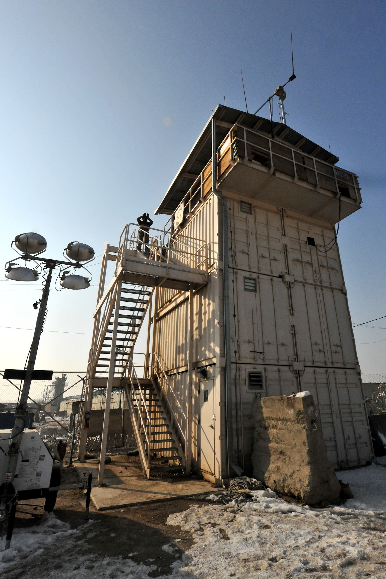 Staff Sgt. Richard Bruin, 455th Expeditionary Security Forces Squadron area supervisor, scans the perimeter around his guard tower on Bagram Airfield, Afghanistan, Jan. 10, 2013. The 455th ESFS man the multiple guard towers that ring the base, armed with powerful binoculars and other hi-tech surveillance gear, looking out into the local community and watching for any threats.  (U.S. Air Force photo/Senior Airman Chris Willis)