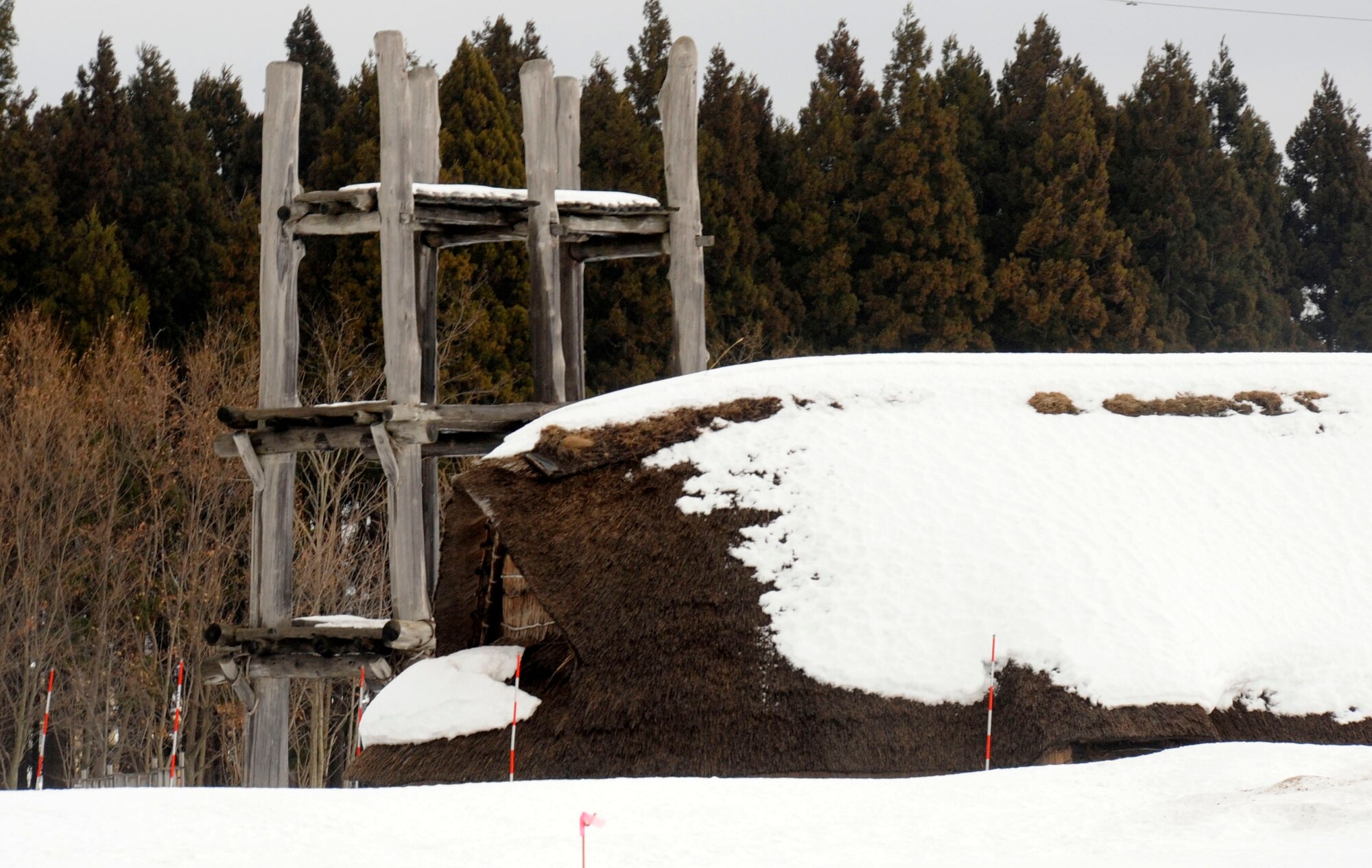 The large six-pillar tower and the longhouse are the largest architectural remains of the Jomon period village and stand at the Sannai-Maruyama site in Aomori, Japan, Feb. 2, 2013. The Sannai-Maruyama historical excavation site is located in Aomori Prefecture in northern Japan and is one of the largest Jomon Period sites. (U.S. Air Force photo by Airman 1st Class Kenna Jackson)