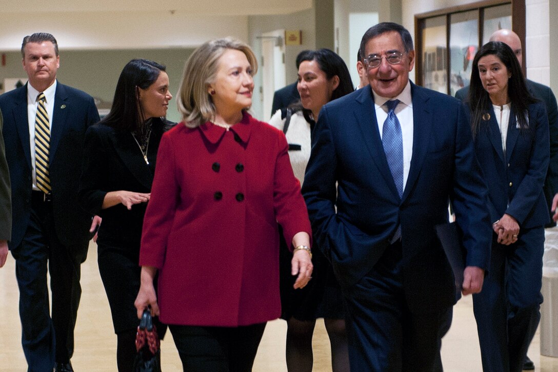 Defense Secretary Leon E. Panetta and Secretary of State Hillary Rodham Clinton walk down a Pentagon corridor in preparation for her farewell tribute and award ceremony on Pentagon, Feb. 14, 2013.