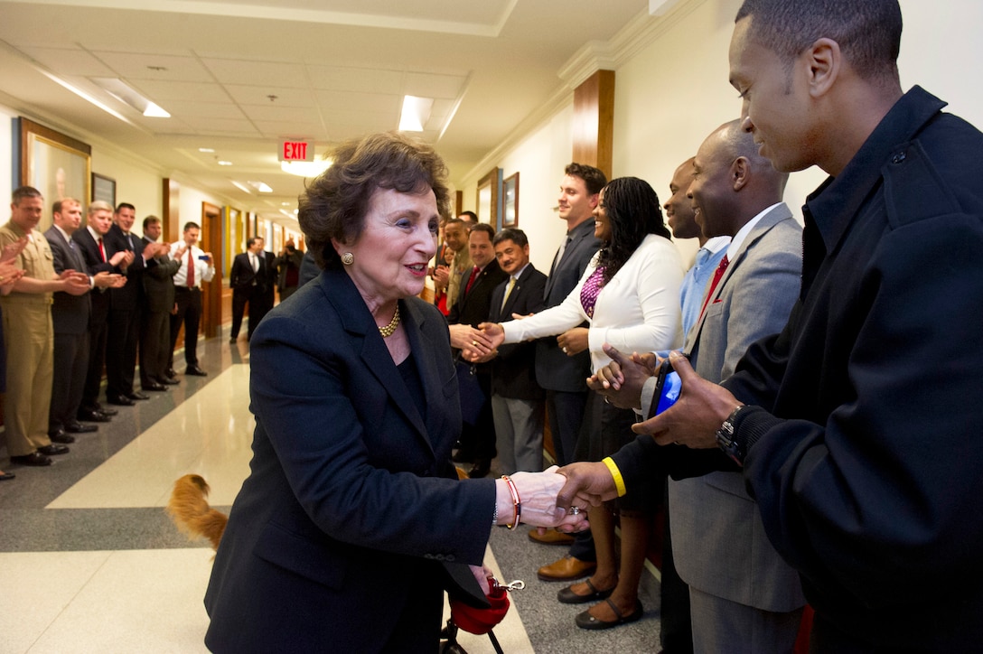 Sylvia Panetta, wife of Defense Secretary Leon E. Panetta, greets cheering Defense Department workers and military members at the Pentagon, Feb. 14, 2013. Panetta will remain secretary of defense until his successor is confirmed and sworn in.