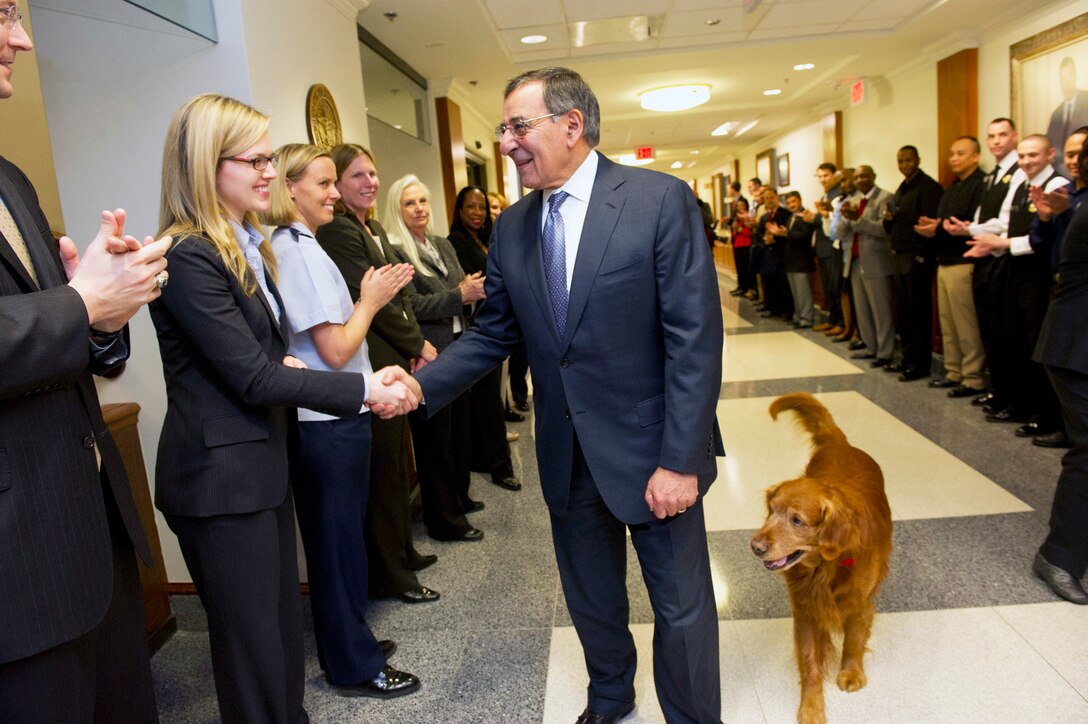Defense Secretary Leon E. Panetta, and his dog, Bravo, greet crowds of cheering Defense Department workers and military members at the Pentagon, Feb. 14, 2013. Panetta will remain secretary of defense until his successor is confirmed and sworn in.