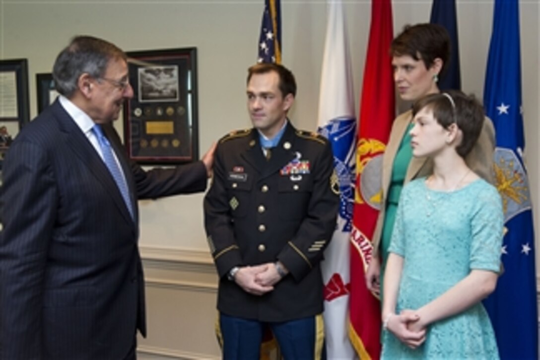 Secretary of Defense Leon E. Panetta talks with former Army Staff Sgt. Clinton Romesha, his wife Tammy and daughter Dessi in his Pentagon office on Feb. 12, 2013.  President Barak Obama presented the Medal of Honor to Romesha in a ceremony yesterday at the White House.  Romesha earned the medal for actions on Oct. 3, 2009, at Combat Outpost Keating in Afghanistan.  