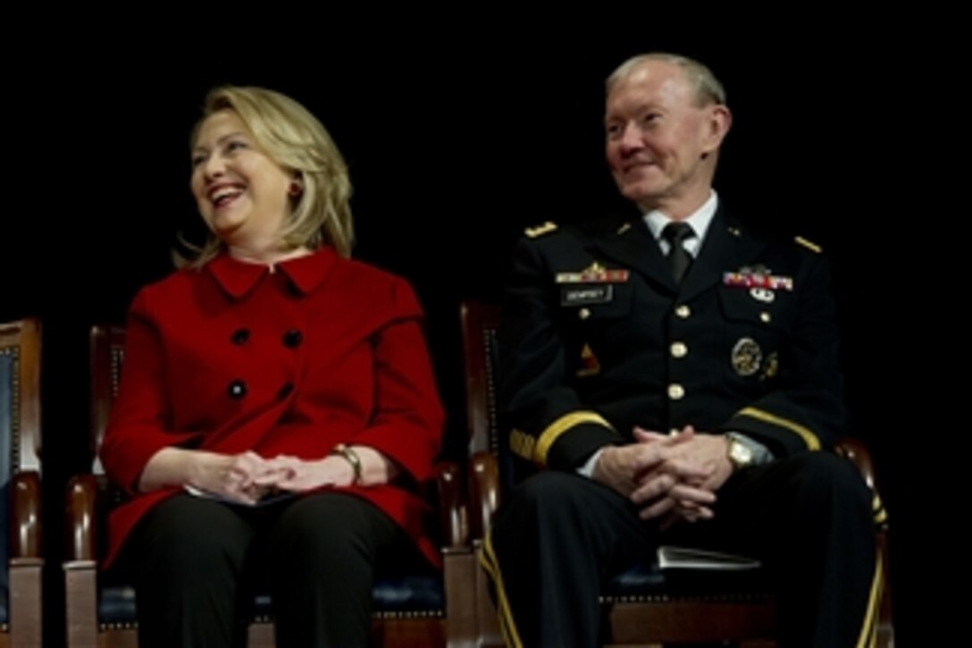 Former Secretary of State Hillary Rodham Clinton and Chairman of the Joint Chiefs of Staff Gen. Martin E. Dempsey laugh at the remarks of Secretary of Defense Leon E. Panetta during an award ceremony for Clinton in the Pentagon on Feb. 14, 2013.  Panetta presented Clinton with the Department of Defense Medal for Distinguished Public Service.  Dempsey awarded Clinton the Joint Distinguished Civilian Service Award.  