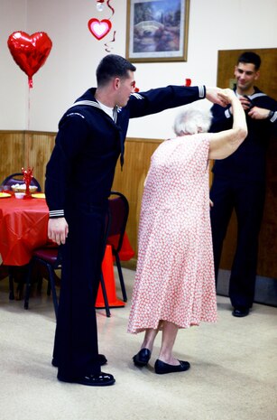 A sailor from Camp Lejeune, N.C., dances with a resident in the ballroom at the Carebridege Assisted Living center in Jacksonville, N.C., Feb. 12, 2013. The facility hosted a Sweetheart Dance and invited Marines from various units to dance, sing, eat and socialize with the residents.