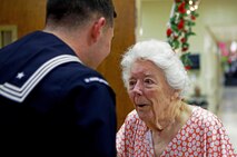 A sailor from Camp Lejeune, N.C., talks to a resident in the ballroom at the Carebridge Assisted Living center in Jacksonville, N.C., Feb. 12, 2013. The facility hosted a Sweetheart Dance and invited Marines from various units to dance, sing, eat and socialize with the residents. 