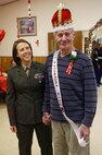 Sgt. Rachael K. A. Moore (Left), a volunteer with 2nd Marine Logistics Group, stands next to the king of the Sweetheart Dance a resident of Carebridge Assisted Living center in Jacksonville, N.C., Feb. 12, 2013. The facility hosted a Sweetheart Dance and invited Marines from various units to dance, sing, eat and socialize with the residents. 