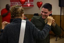 Lance Cpl. Matthew S. Hartlove, a Baltimore native and electrician with 2nd Supply Battalion, 2nd Marine Logistics Group, dances with the queen of the Sweetheart Dance a resident of Carebridge Assisted Living center in Jacksonville, N.C., Feb. 12, 2013. The facility hosted a Sweetheart Dance and invited Marines from various units to dance, sing, eat and socialize with the residents. 