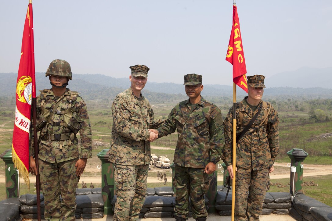 U.S. Marine Lt. Col. Chris P. O'Connor (left center) and Royal Thai Marine Lt. Cmdr. Banjerd Adium shake hands during the opening ceremony Feb. 11 announcing the start of the exercise Cobra Gold 2013 field training exercises in Ban Chan Krem, Kingdom of Thailand. Cobra Gold is a recurring, multinational and multiservice exercise hosted annually by Thailand and developed by the Thai and U.S. militaries. CG 13 also includes humanitarian and civic assistance projects and a staff exercise. Adium is the commanding officer of 3rd Battalion, 1st Infantry, Royal Thai Marines and O'Connor is the commanding officer of 1st Battalion, 3rd Marine Regiment, 3rd Marine Division, III Marine Expeditionary Force.