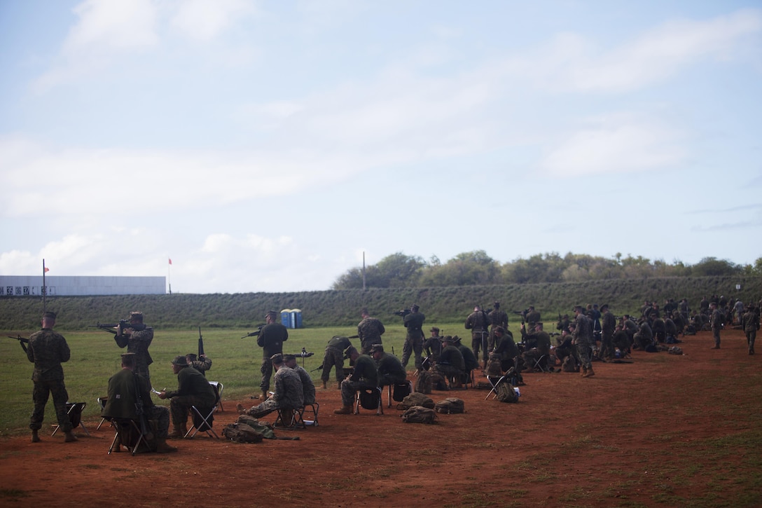 PUULOA RANGE TRAINING FACILITY, Ewa Beach, Hawaii - Service members line up on the firing line during the Pacific Division Matches at Puuloa Range Training Facility, Monday. Marines had to fire through their individual base and regional competitions before competing at the division level. Once placed in the top of a division, Marine shooters are chosen to compete in the Marine Corps Shooting Championship. (U.S. Marine Corps photo by Lance Cpl. Nathan Knapke/Released) 