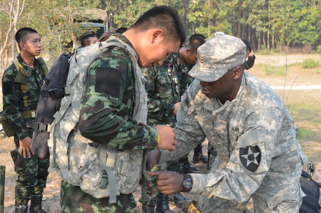 A U.S. Army soldier, right, conducts a weapons familiarization class with Royal Thai Army soldiers Feb. 12 prior to conducting live-fire marksmanship training at Camp Borokthai in Phitsanulok province, Kingdom of Thailand, during the field training portion of exercise Cobra Gold 2013. U.S. involvement in CG 13 demonstrates commitment to building military-to-military interoperability with participating nations and to supporting peace and stability in the region. Thai soldiers are with 1st Battalion, 7th Regiment, 7th Division, RTA, and U.S. soldiers are with 2nd Battalion, 9th Infantry Regiment, 1st Armored Brigade Combat Team, 2nd Infantry Division.