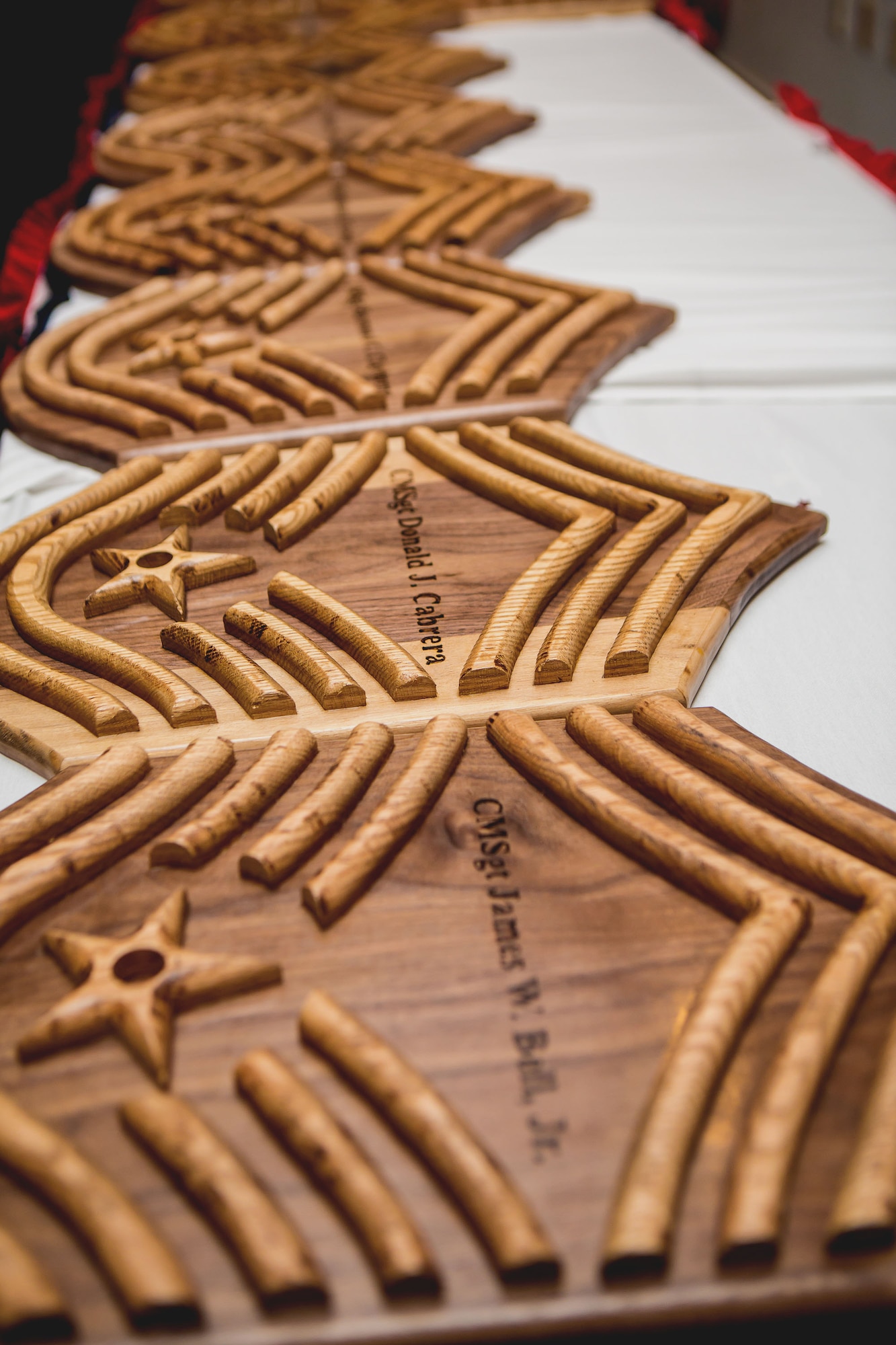 Commemorative plaques line a table at the Chief Master Sergeant Induction Ceremony at the Tradewinds Enlisted Club on Joint Base Pearl Harbor-Hickam, Hawaii, Feb. 1. Twelve newly selected chief master sergeants were welcomed into the top one percent of the Air Force in a formal ceremony where Pacific Air Forces Command Chief, Steve McDonald, served as the guest speaker. (Courtesy photo)