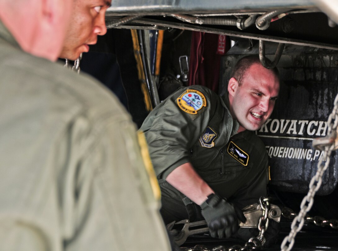 Senior Airman Noel Jones, 36th Airlift Squadron loadmaster from Yokota Air Base, Japan, secures the R-11 refueling truck on a C-130 Hercules at Andersen Air Force Base, Guam, Feb. 13, 2013. With the combined effort of Airmen from the 374th Aircraft Maintenance Squadron, and 36th AS, both from Yokota AB, Japan and currently on Guam for Cope North 13, and the Airmen of the 36th Logistics Readiness Squadron and 734th Air Mobility Squadron, the refueling truck was transported to Rota and successfully refueled a Navy F/A-18 Hornet diverted to Rota due to weather conditions. (U.S. Air Force photo by Airman 1st Class Marianique Santos/Released)