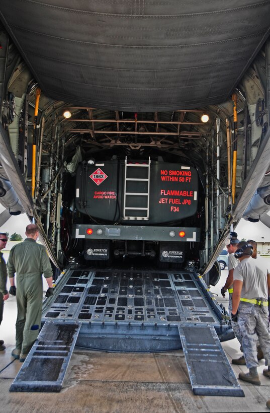 An R-11 refueling truck pulls into the cargo hold of a C-130 Hercules on Andersen Air Force Base, Guam, Feb. 13, 2013. Andersen Airmen, along with Airmen from units in support of Cope North 13, transported the R-11 refueling truck to Rota island in order to recover a Navy F/A-18 Hornet that diverted due to weather conditions. (U.S. Air Force photo by Airman 1st Class Marianique Santos/Released)