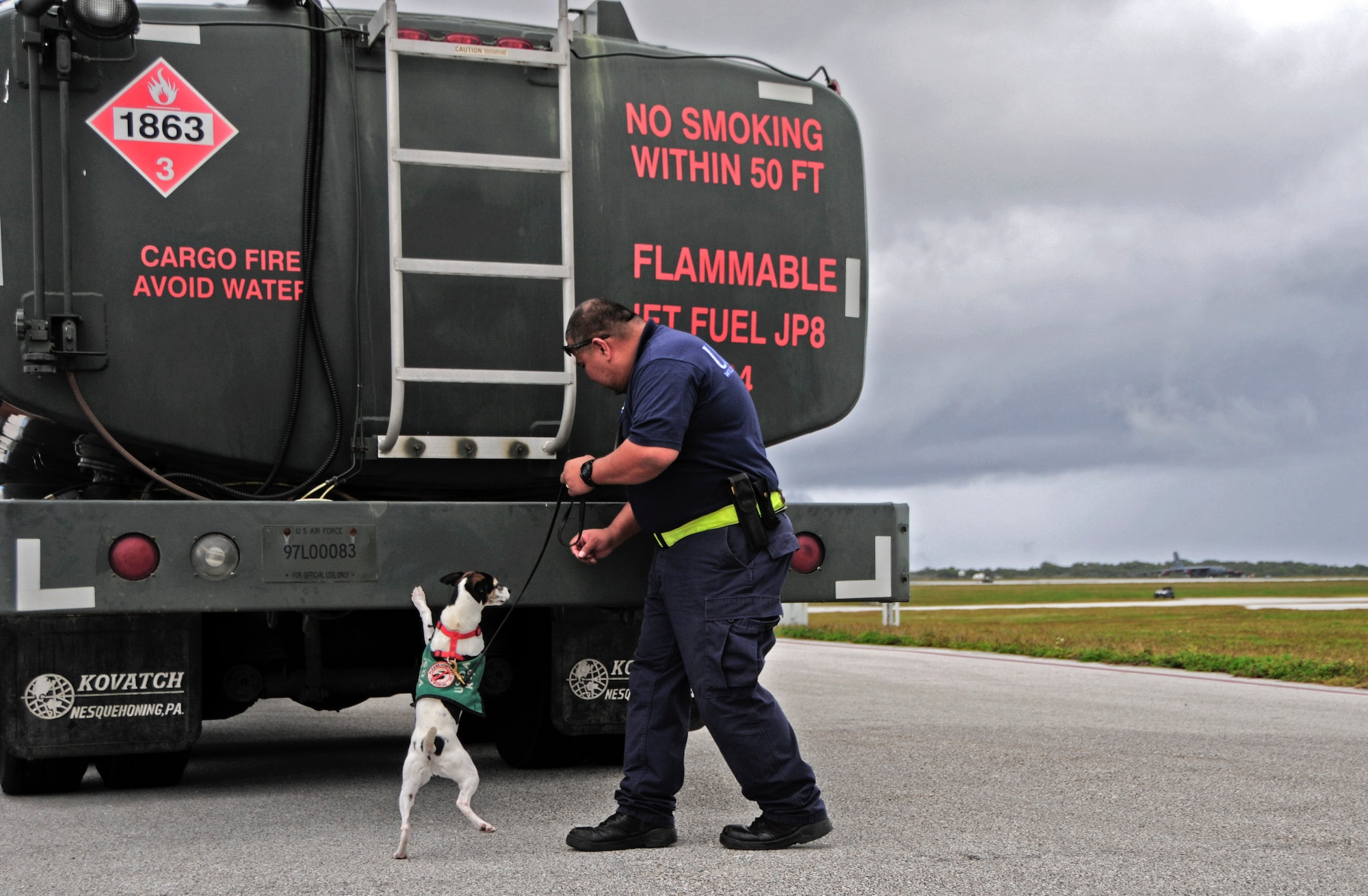 A U.S. Department of Agriculture K-9 and his handler inspect an R-11 refueling truck at Andersen Air Force Base, Guam, Feb. 13, 2013. Andersen Airmen, along with Airmen from units in support of Cope North 13, transported the R-11 refueling truck to Rota island in order to recover a Navy F/A-18 Hornet that diverted due to weather conditions. (U.S. Air Force photo by Airman 1st Class Marianique Santos/Released)