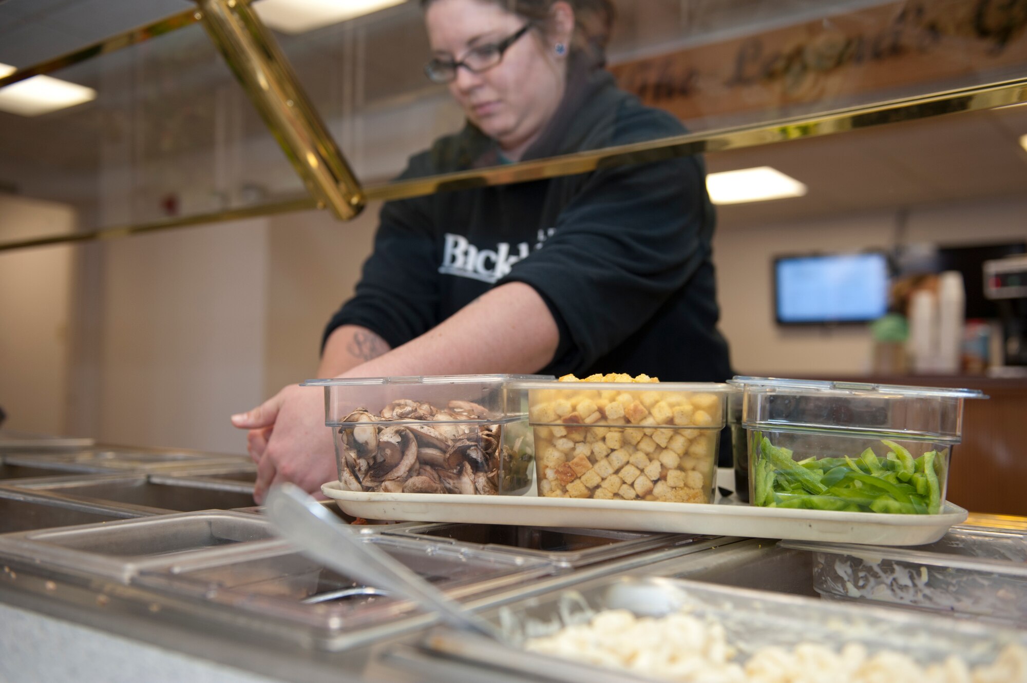 An employee at the Apache Mesa Golf Course prepares salad ingredients for customers during the lunch hour at Holloman Air Force Base, N.M., Feb. 15. The Apache Mesa Golf Club now has a soup and salad bar to replace the one that was previously located at the Raptors Nest. It is also home to the Contingency Operating Bar Raptor, or COB Raptor, on Friday nights.(U.S. Air Force photo by Airman 1st Class Colin Cates/Released) 