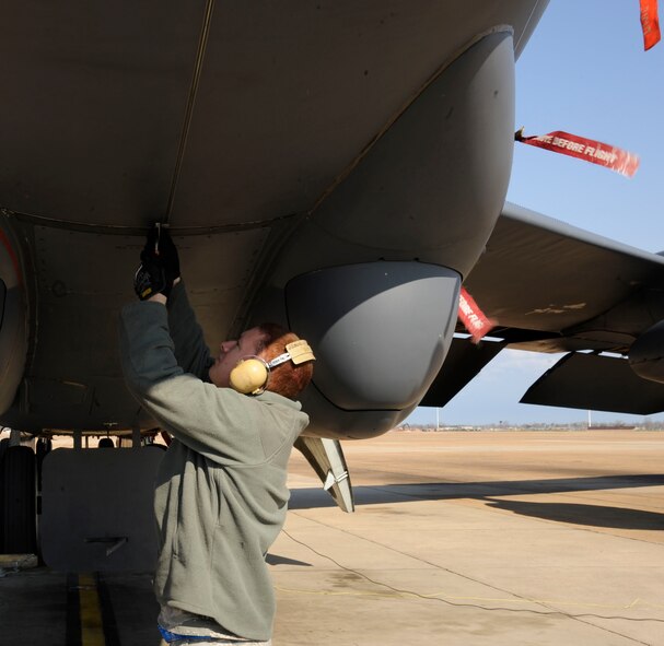 Senior Airman Kevin Rhinehart, 2nd Aircraft Maintenance Squadron, prepares to open the nose of a B-52H Stratofortress to access the radar on Barksdale Air Force Base, La., Feb. 15. The B-52s radar enables it to find and locate objectives for its mission of bringing precision munitions to the battlefield. (U.S. Air Force photo/Airman 1st Class Andrew Moua)