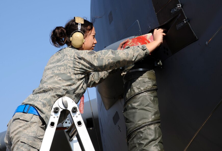 Senior Airman China Whitwer, 2nd Aircraft Maintenance Squadron, hooks up an air conditioning unit to a B-52H Stratofortress on Barksdale Air Force Base, La., Feb. 15. The unit provides ventilation, heating, and air conditioning to provide a fresh source of air for aircrew. (U.S. Air Force photo/Airman 1st Class Andrew Moua)