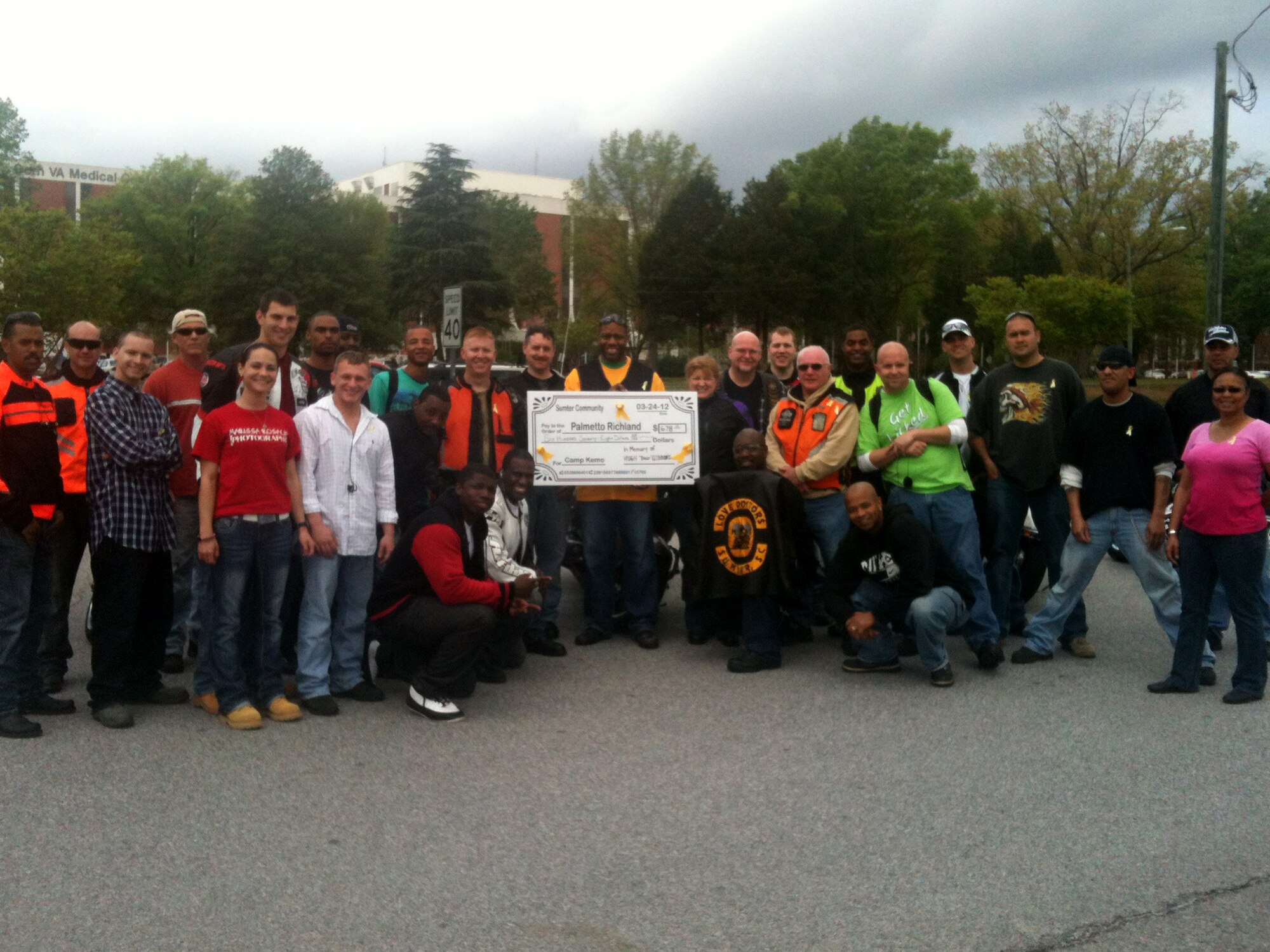 Motorcyclists gather together to present the money raised during the Annual Bear Crawl motorcycle fundraiser. The event is named in honor of Hugh "Bear" Gibbons who passed away on Valentine's Day 2011 at the age of seven. All proceeds from the event will go to children with the childhood cancr Hepatoblastoma. (Courtesy photo by Master Sgt. Maurice Toole/ Released)