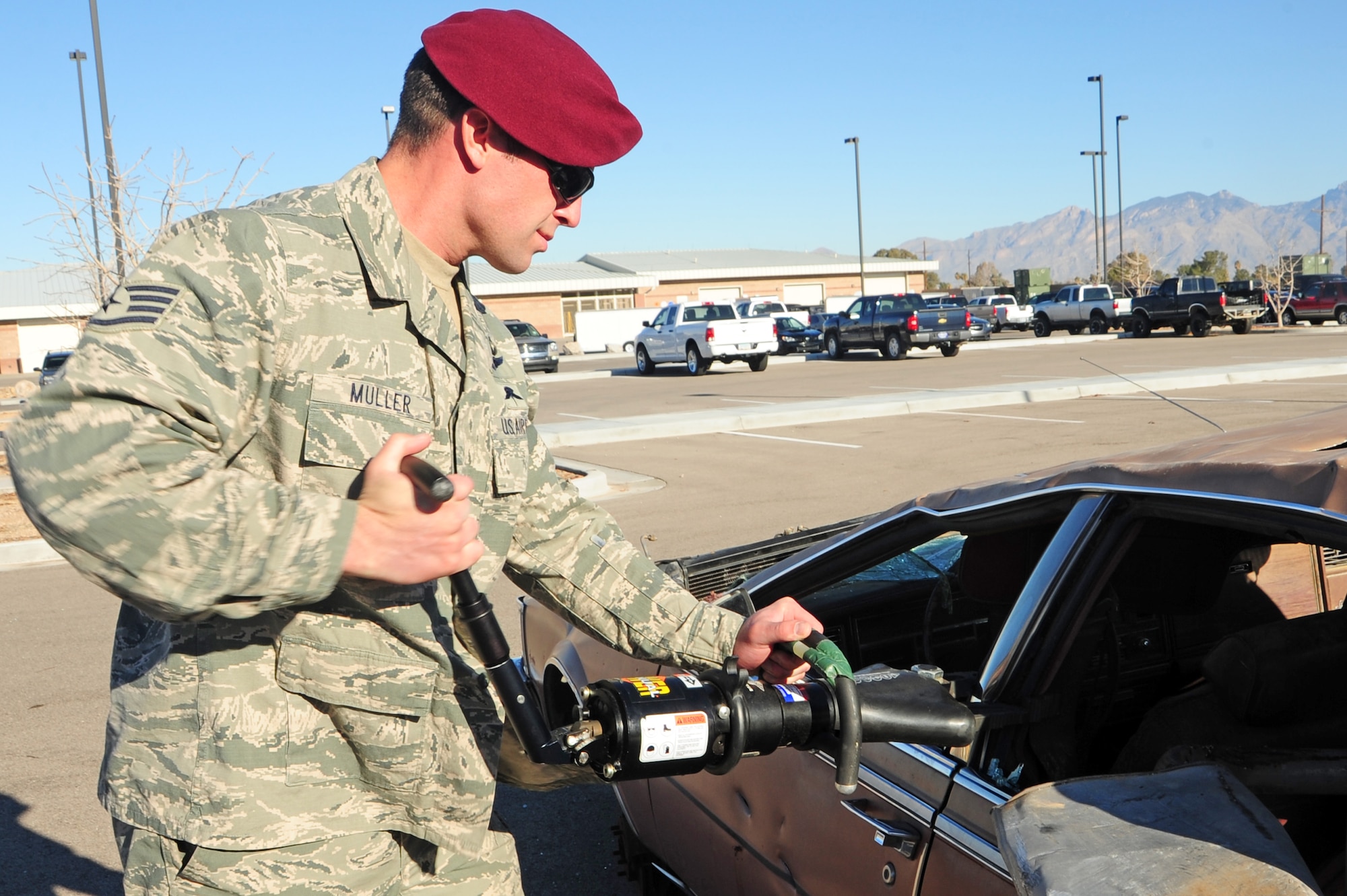 U.S. Air Force Staff Sgt. Michael Muller, 48th Rescue Squadron pararescueman, uses the jaws of life to cut through a support beam of a vehicle at Davis-Monthan Air Force Base, Ariz., Feb. 13, 2013. Depending on the car, beams can be cut in less than five minutes. (U.S. Air Force photo by Airman 1st Class Camilla A Griffin/Released)