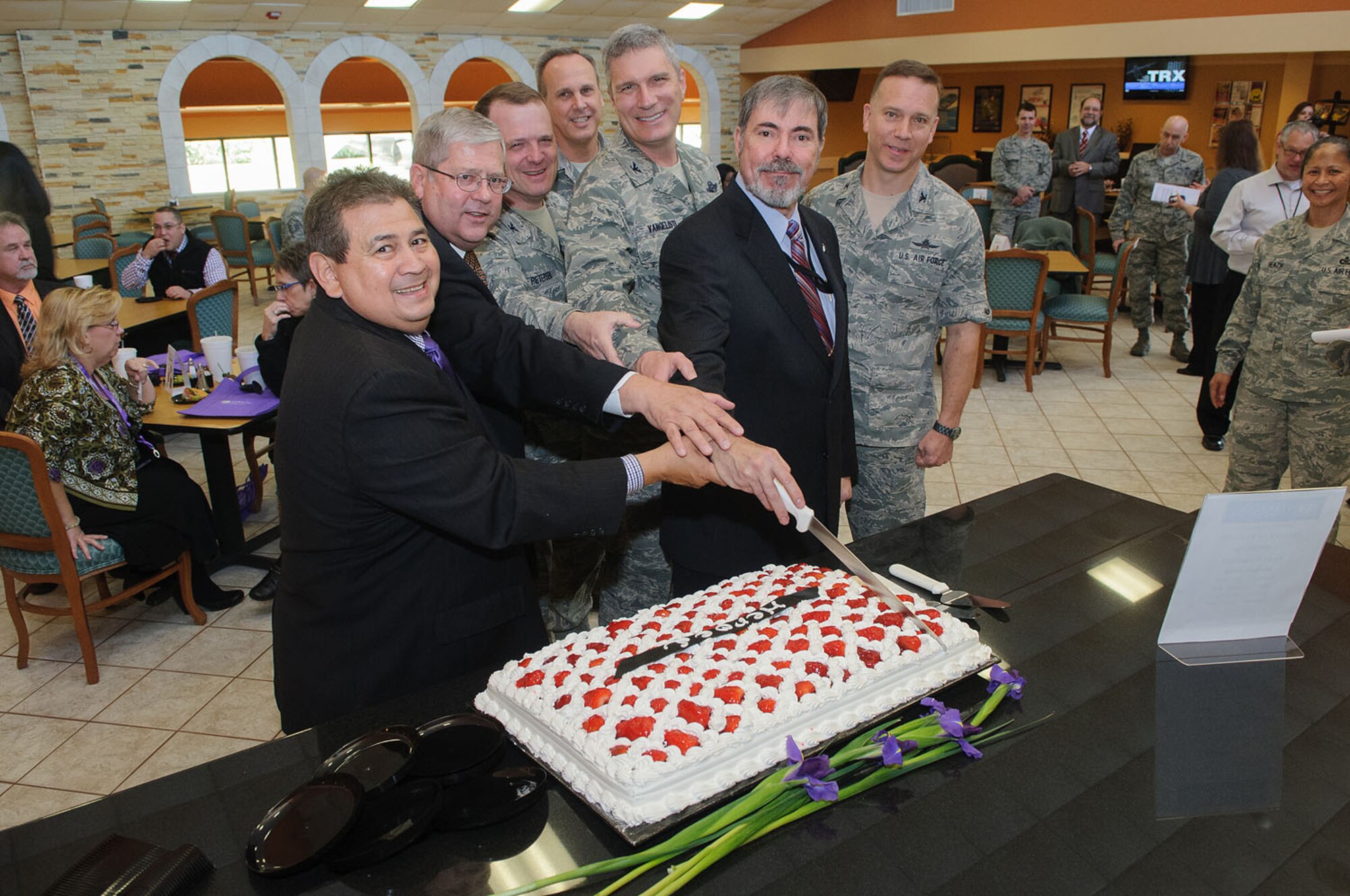 Senior leaders from JBSA-Lackland that will benefit the most from the opening of the Gott Commons Community Center and Heroes restaurant, pose for a photo just prior to cutting the cake during a private tour and tasting event Feb.13.  (Left to Right) Rick Aleman, President, Selrico Services, Inc., Ken Williams, director of staff, Air Force Intelligence, Surveillance and Reconnaissance Agency, Gregory Radabaugh, director, Joint Information Operations Warfare Center, Col. Craig Petersen, 433rd Mission Support Group commander and Col. Vice Commander Aaron Vangelisti, 433rd Airlift Wing, Commander, Col. Patrick Kelly, Air Force Security Forces Center and Col. William Eger, 802nd Mission Support Group commander.(U.S. Photo/William Belcher)   
